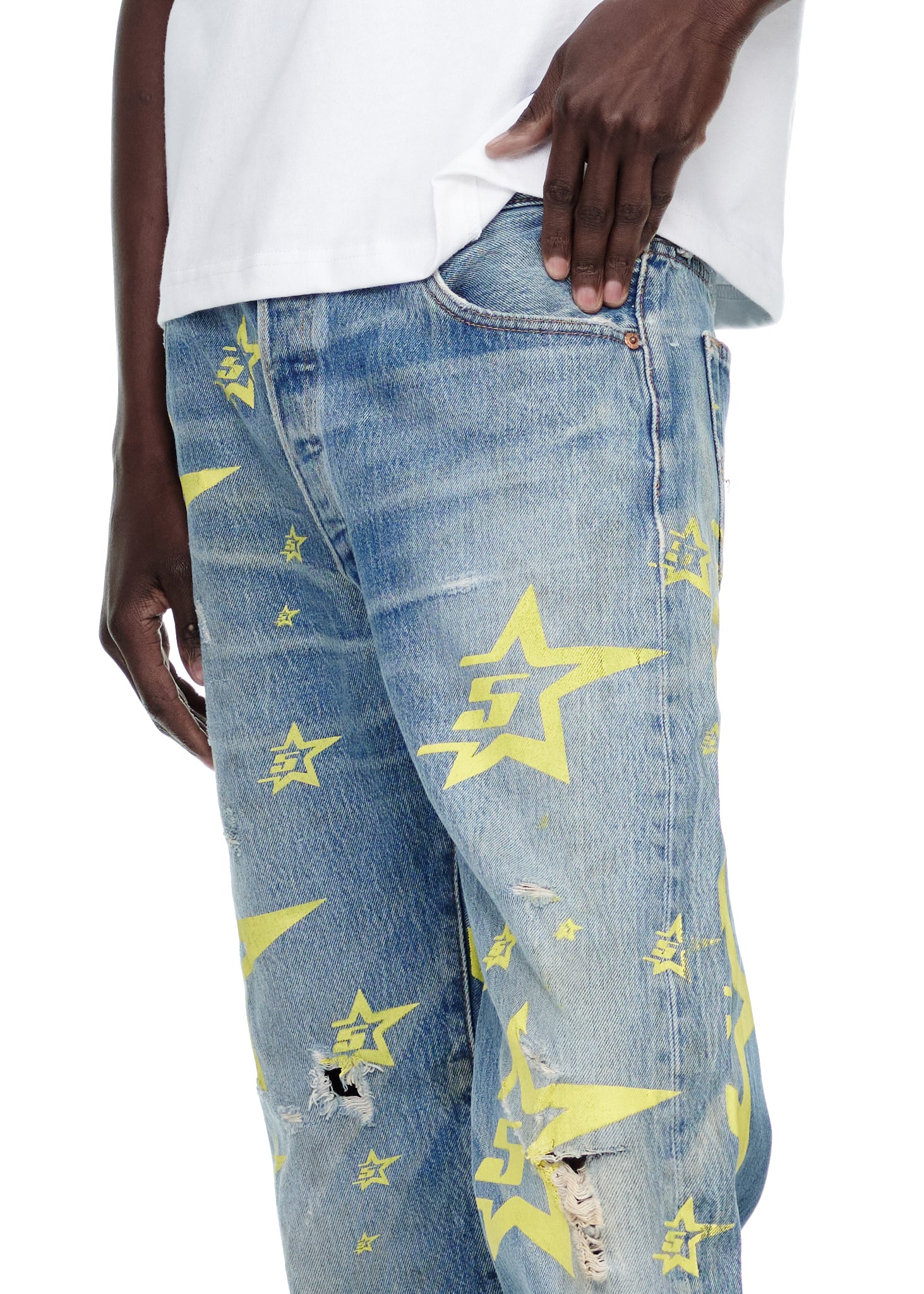 Vintage Levi's 501 denim jeans with yellow 5STAR print stars and distressed details.