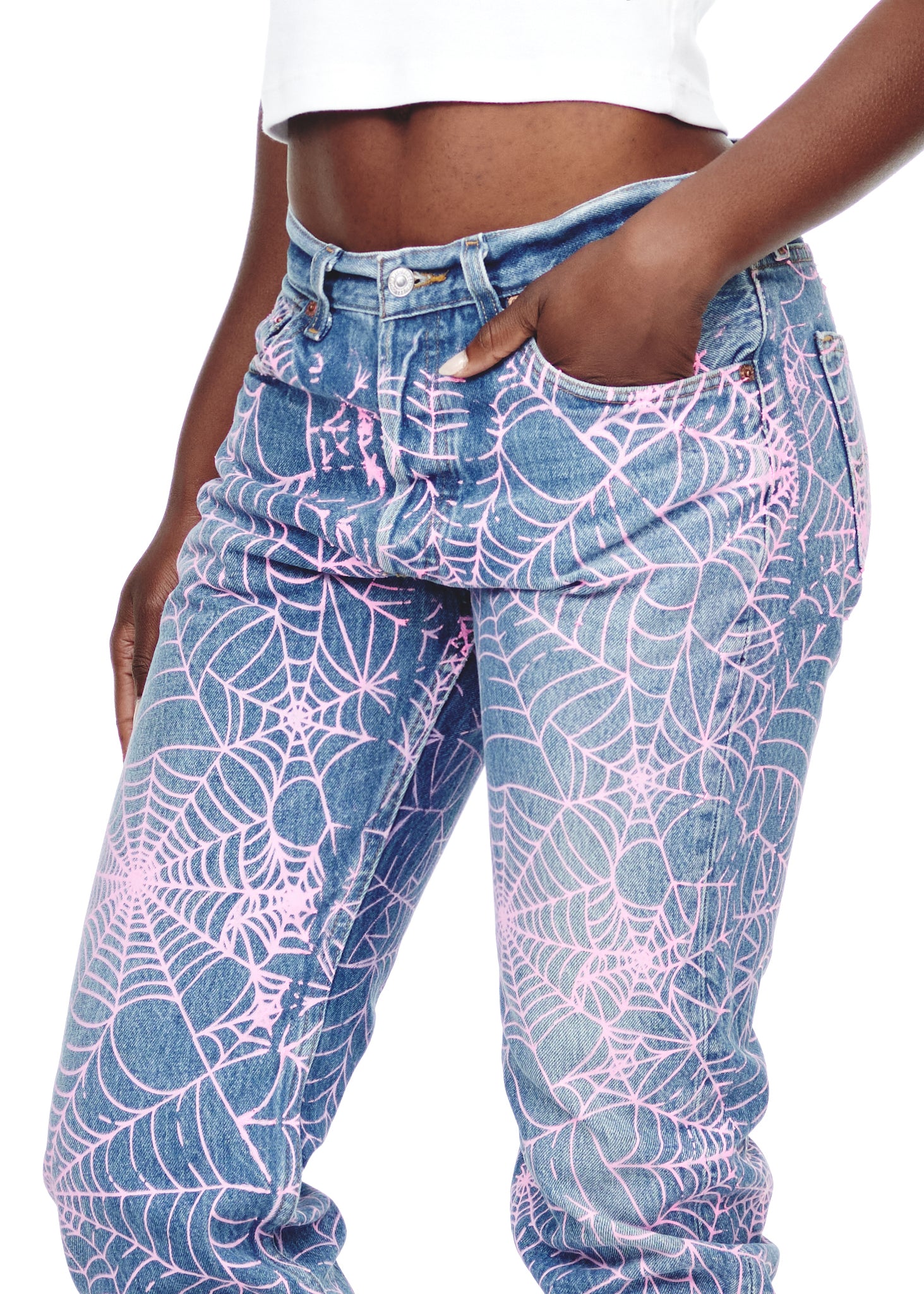 Vintage Levi's 501 denim jeans with all-over pink spider web print, worn by a model.