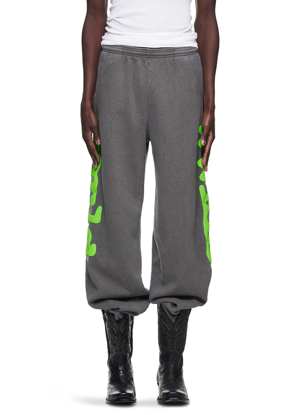Slate grey Beluga sweatpants with neon green 'Worldwide' puff print down both legs.