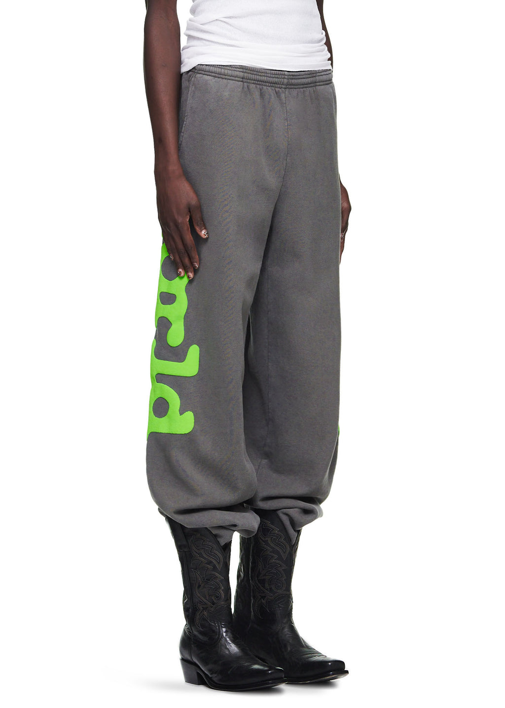 Slate grey Beluga sweatpants with neon green "Worldwide" puff print down the legs, worn by a male model.