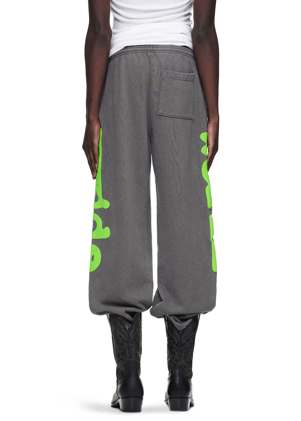 Slate grey Beluga sweatpants with bright green "Worldwide" puff print down both legs, worn by a male model.