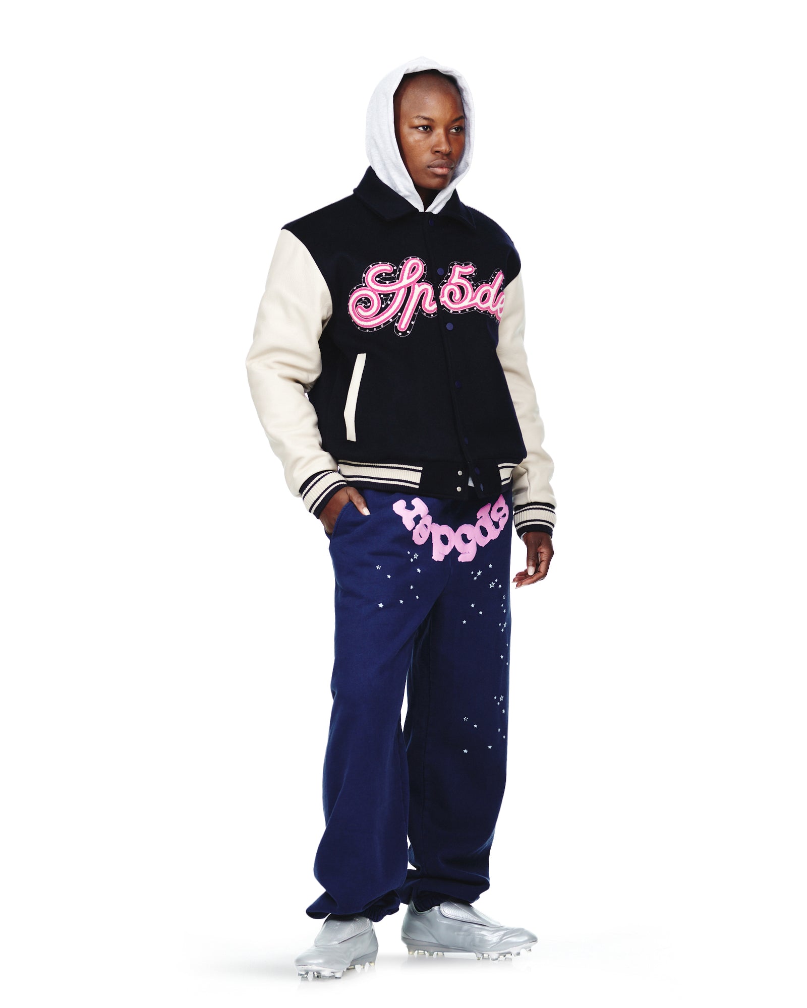 Navy wool varsity jacket with cream cowhide sleeves, pink chenille patches, and contrast leather welt pockets.