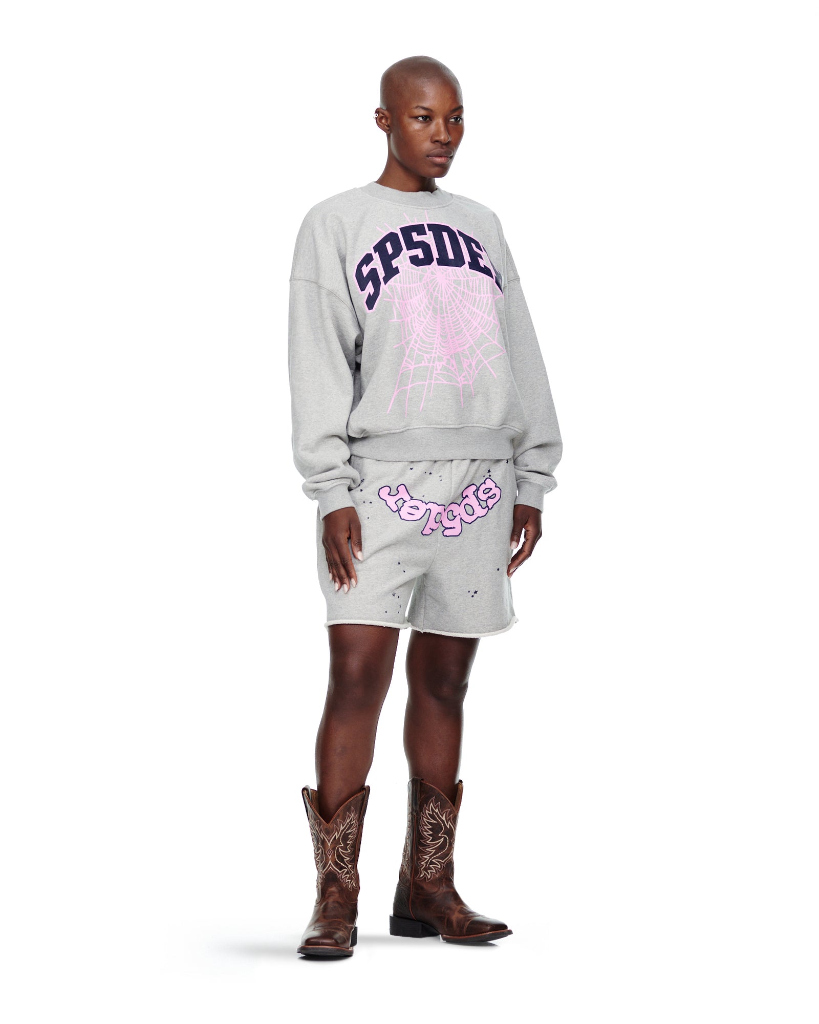 Gray VARSITY WEB CREWNECK with purple "SPSDE" and pink spider web print, worn by a model.