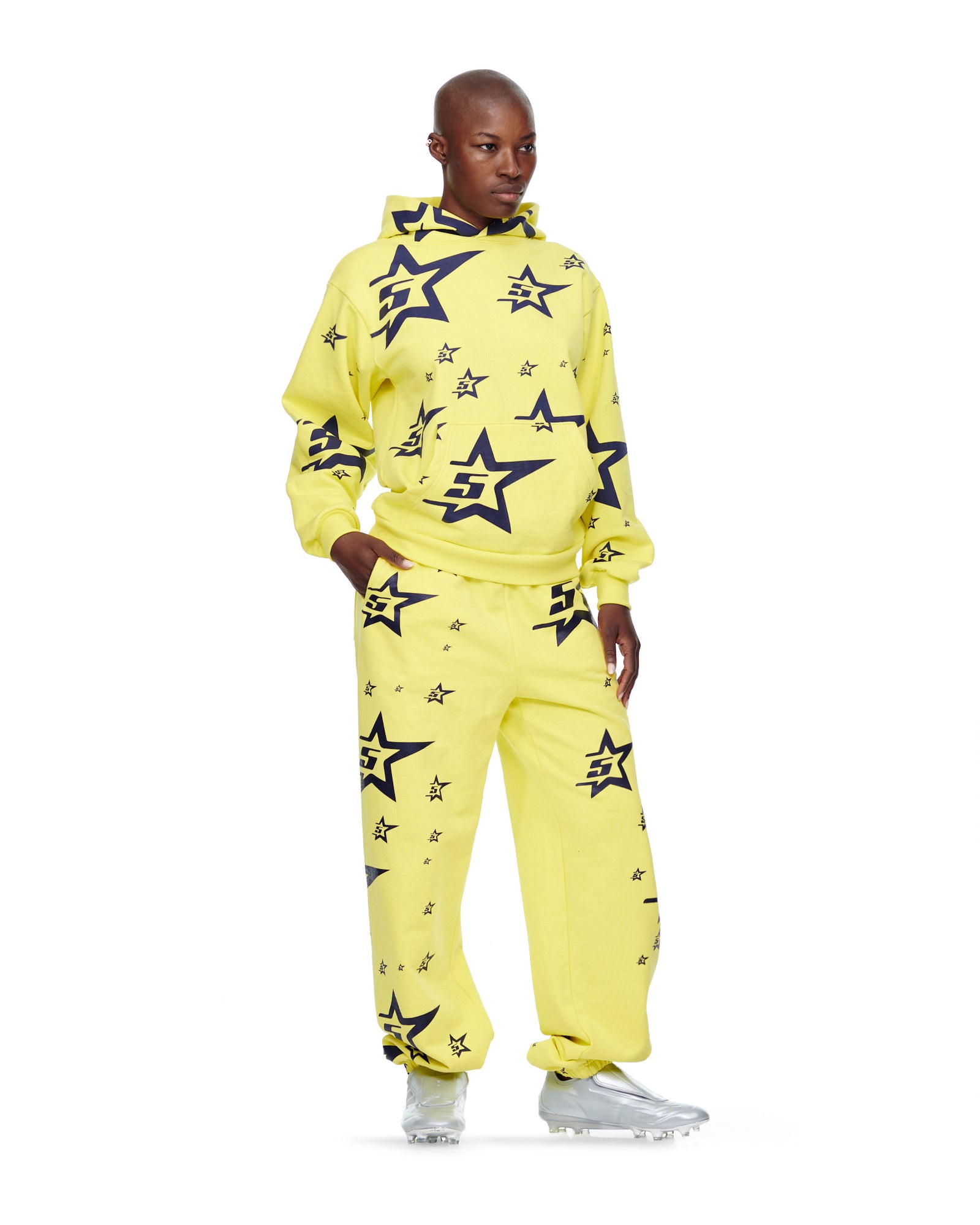 Yellow 23oz fleece 5STAR HOODIE and sweatpants with all-over navy star print, worn by a model.