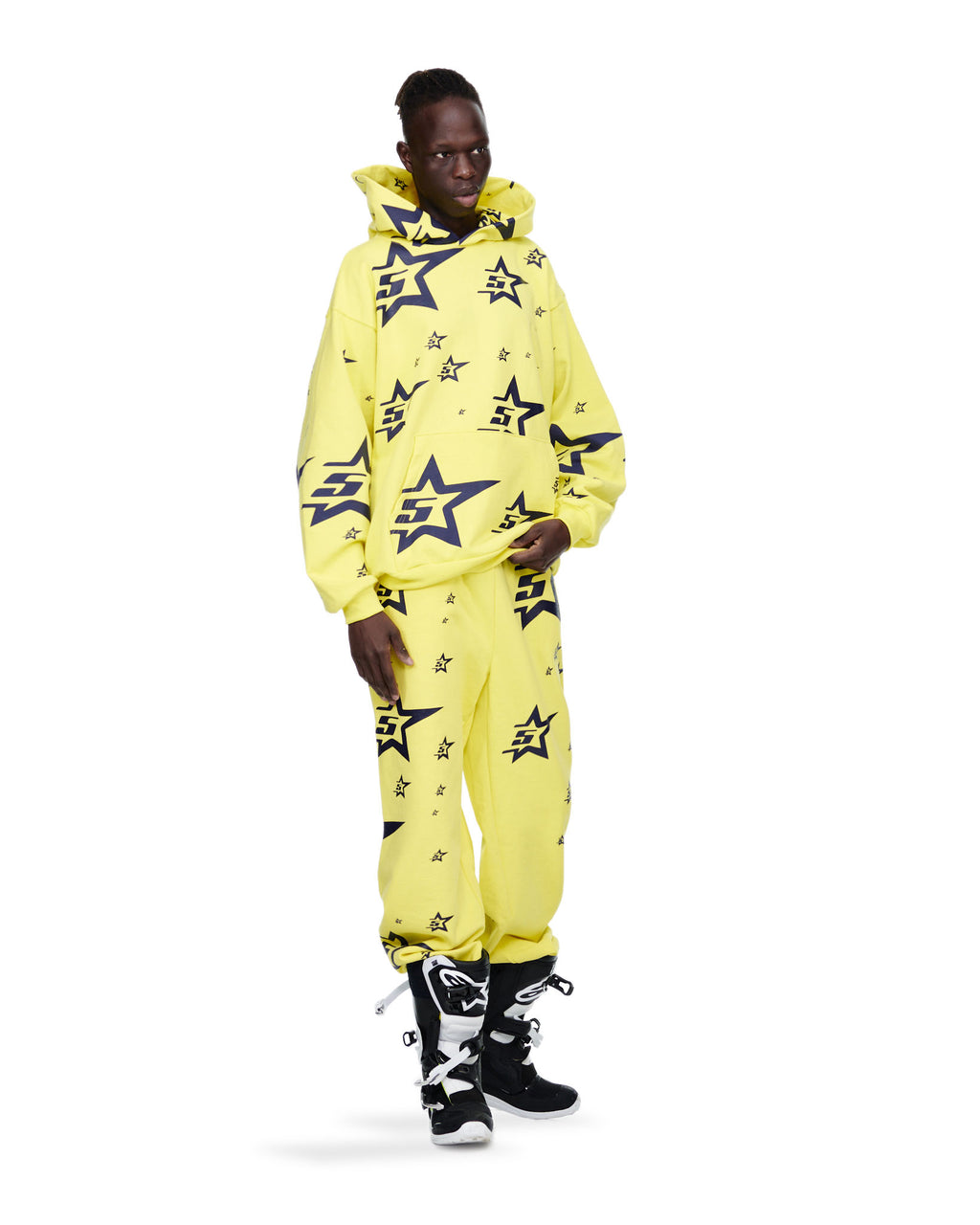 Yellow 5STAR HOODIE and sweatpants set with all-over dark blue star print, worn by a model.