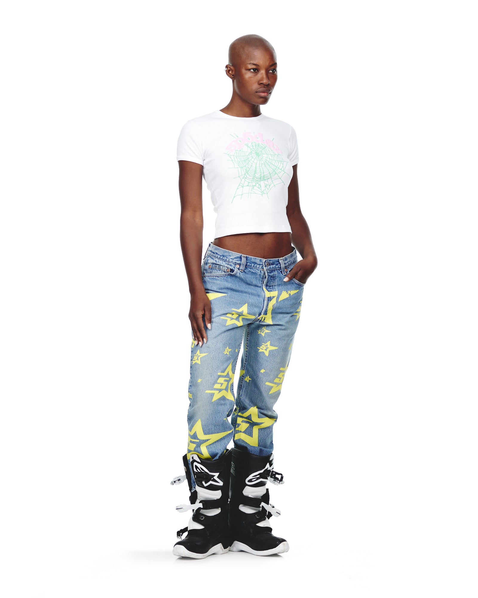 Female model in vintage Levi's 501 denim with yellow 5STAR print, white crop top, and black boots.