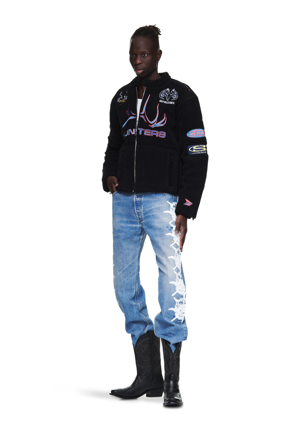 Black sherpa moto jacket with custom SP5DER patches, embroidery, leather trim, and zip closure.