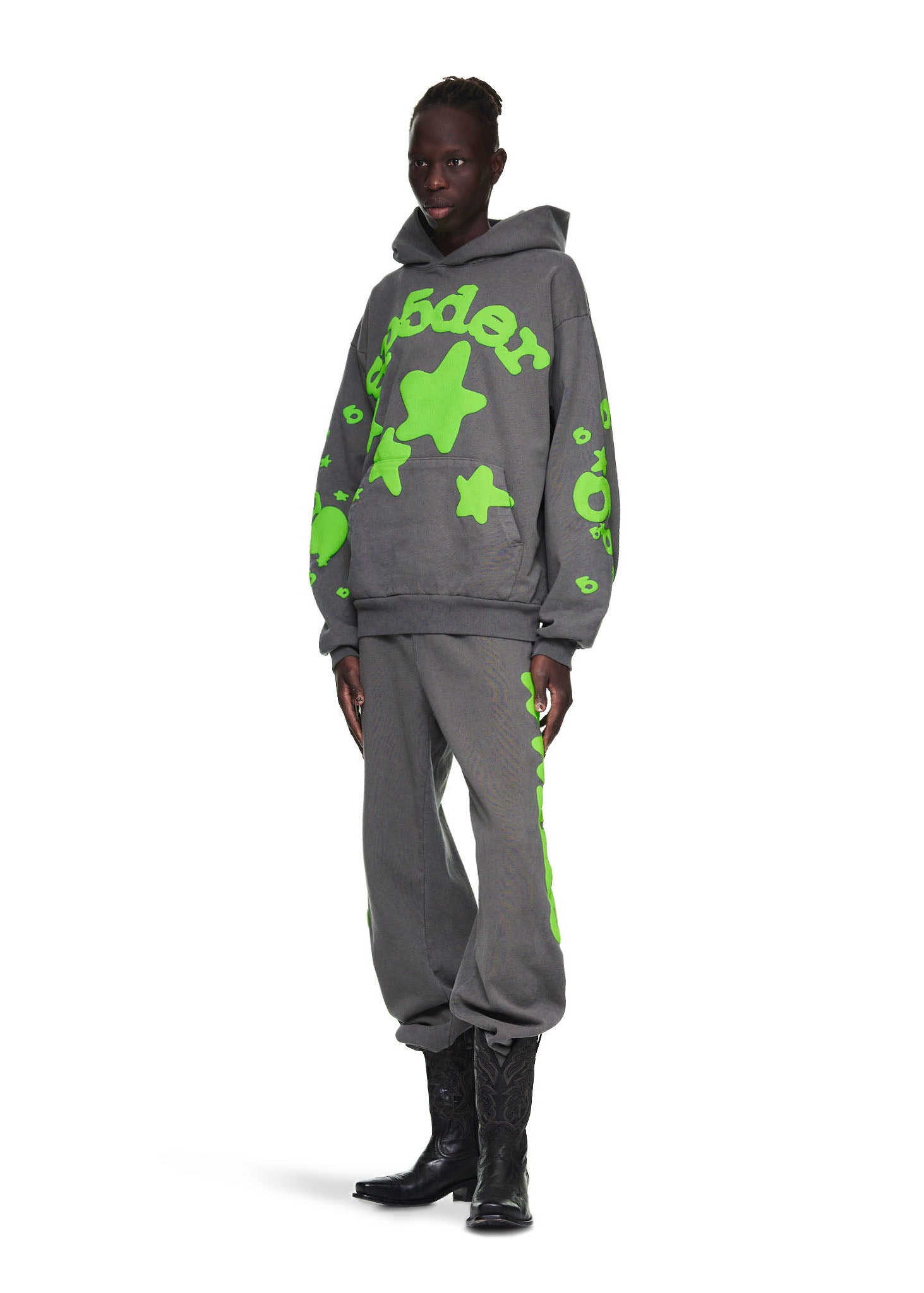 Male model in slate grey Beluga hoodie and sweatpants with neon green "SP5DER" and star puff print.