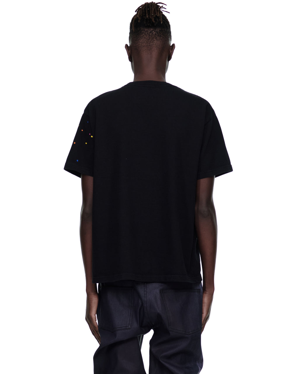 Back view of a black cotton MEN'S OG WEB V2 TEE with colorful star accents on the left sleeve.
