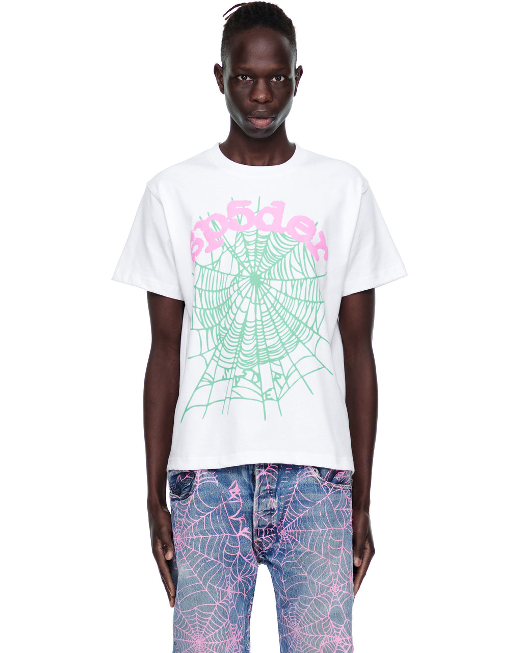 Male model in white 100% cotton OG WEB CANDY TEE with pink text and green spiderweb print.