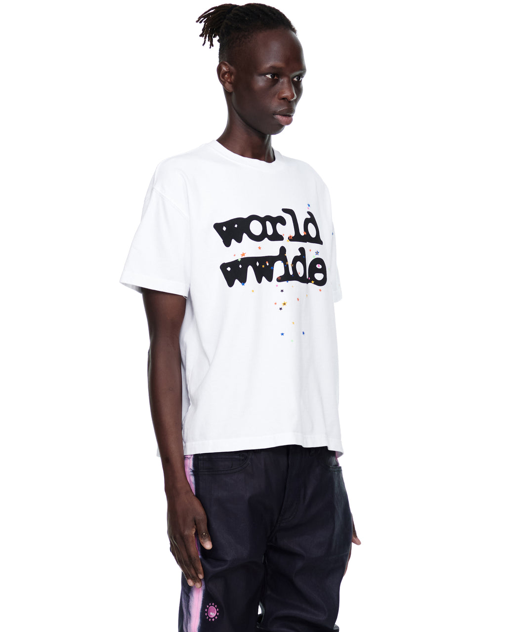 Men's white 14oz cotton Worldwide tee with black text and colorful speckles, worn by a male model.