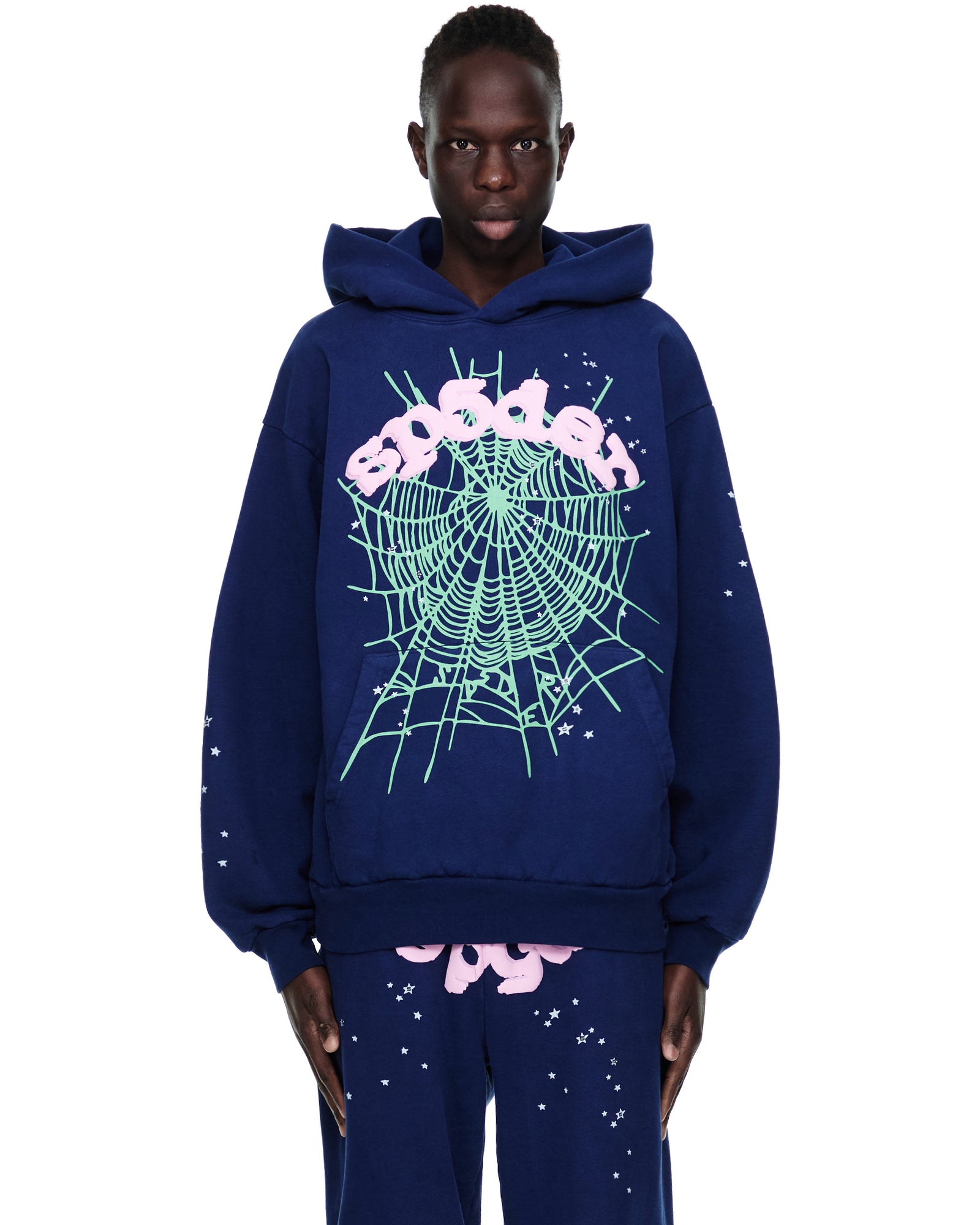 Navy blue OG WEB HOODIE with pink "SP5DER" text and glow-in-the-dark green web print.