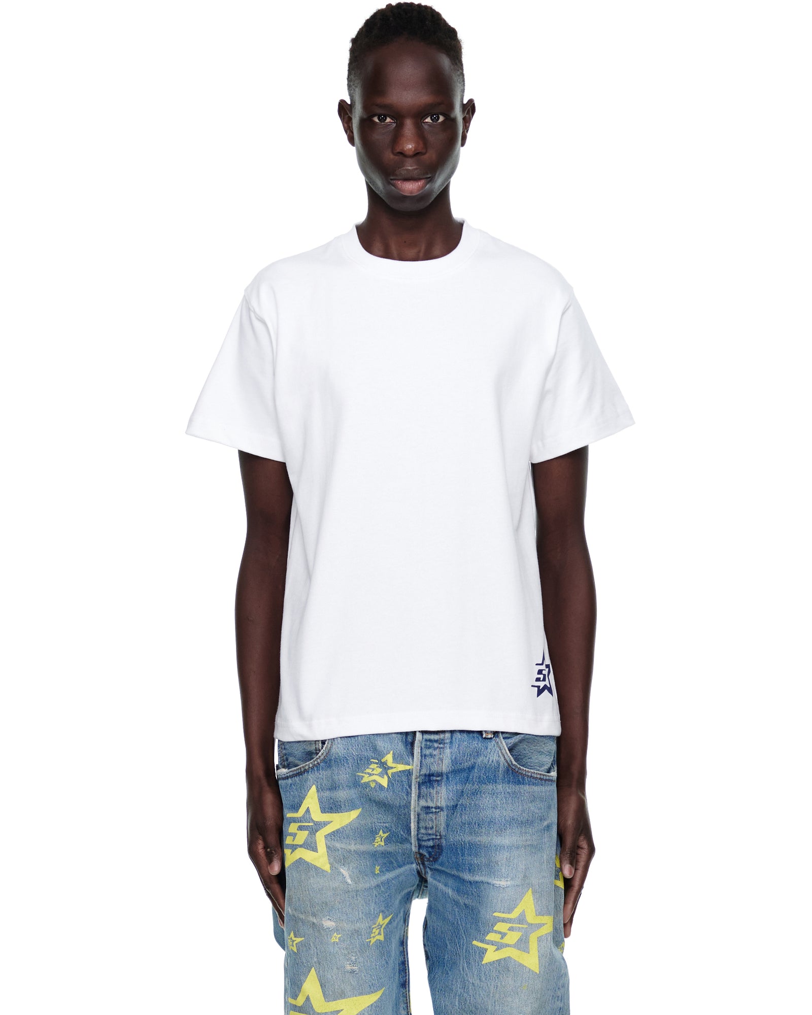 Male model wears a white 100% cotton 5STAR UTILITY TEE with a small blue 5STAR graphic on the corner hem.