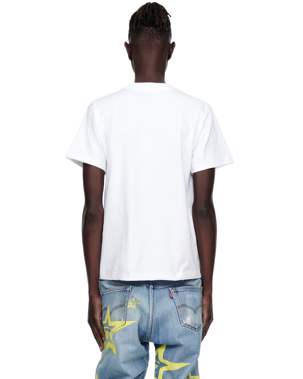 Back view of a male model wearing a white 5STAR UTILITY TEE, 100% cotton, with light wash jeans.