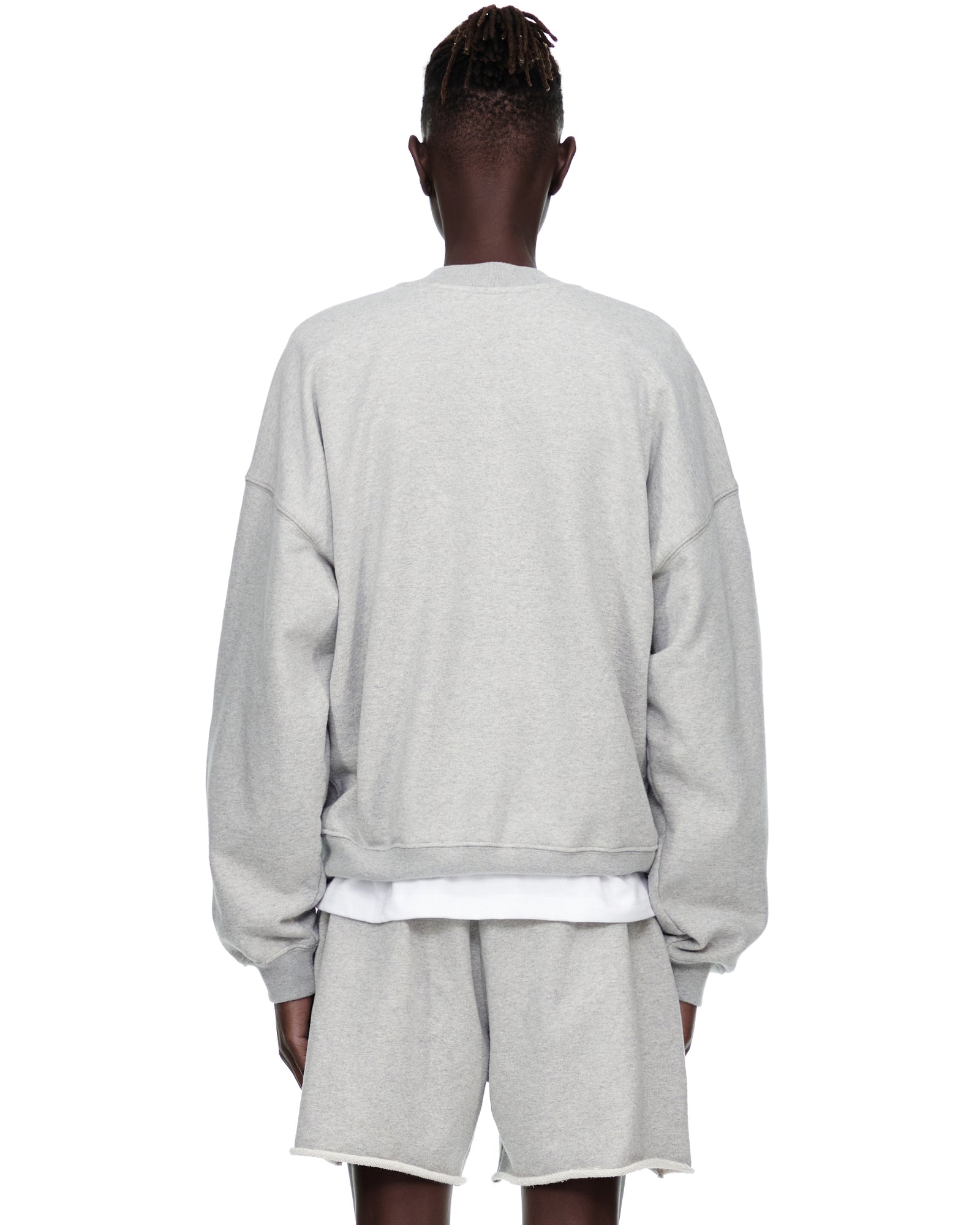 Grey VARSITY WEB CREWNECK sweatshirt and matching shorts on a model, back view.