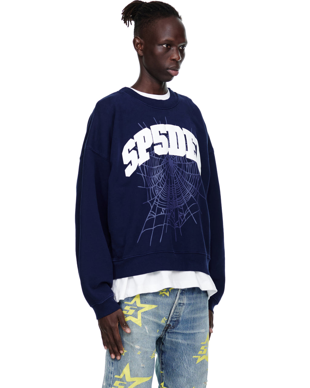 Male model in a navy VARSITY WEB CREWNECK with white "SP5DER" text and a spider web graphic.