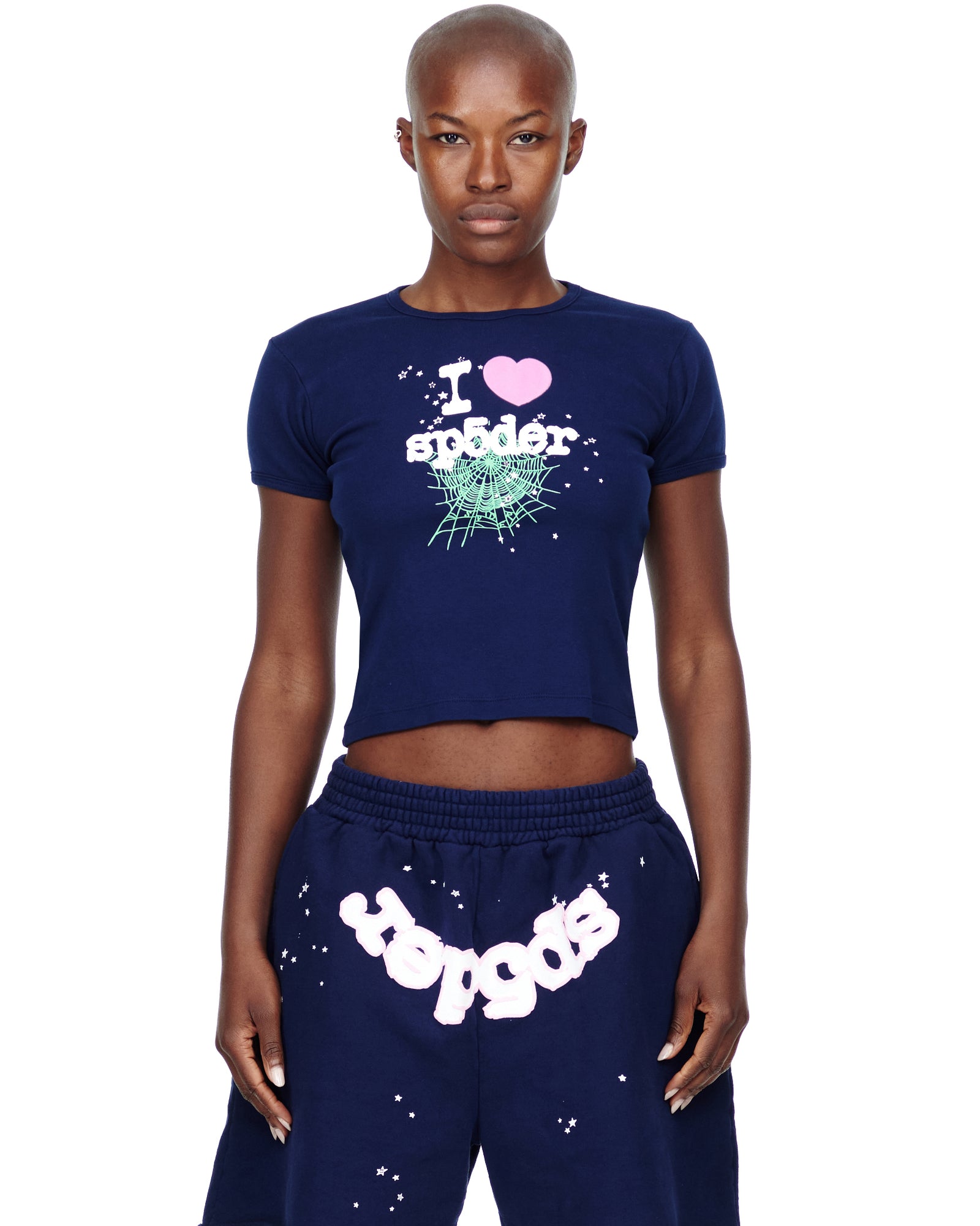 Female model in navy cropped cotton baby tee with "I heart sp5der" graphic and matching sweatpants.