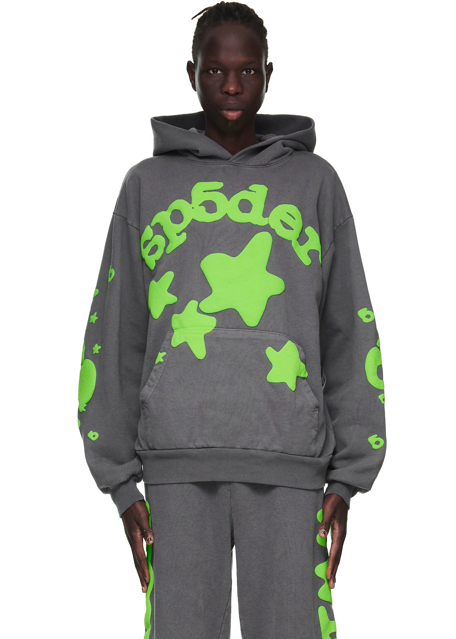Male model in slate grey Beluga hoodie with neon green 'SP5DER' text and star puff prints.