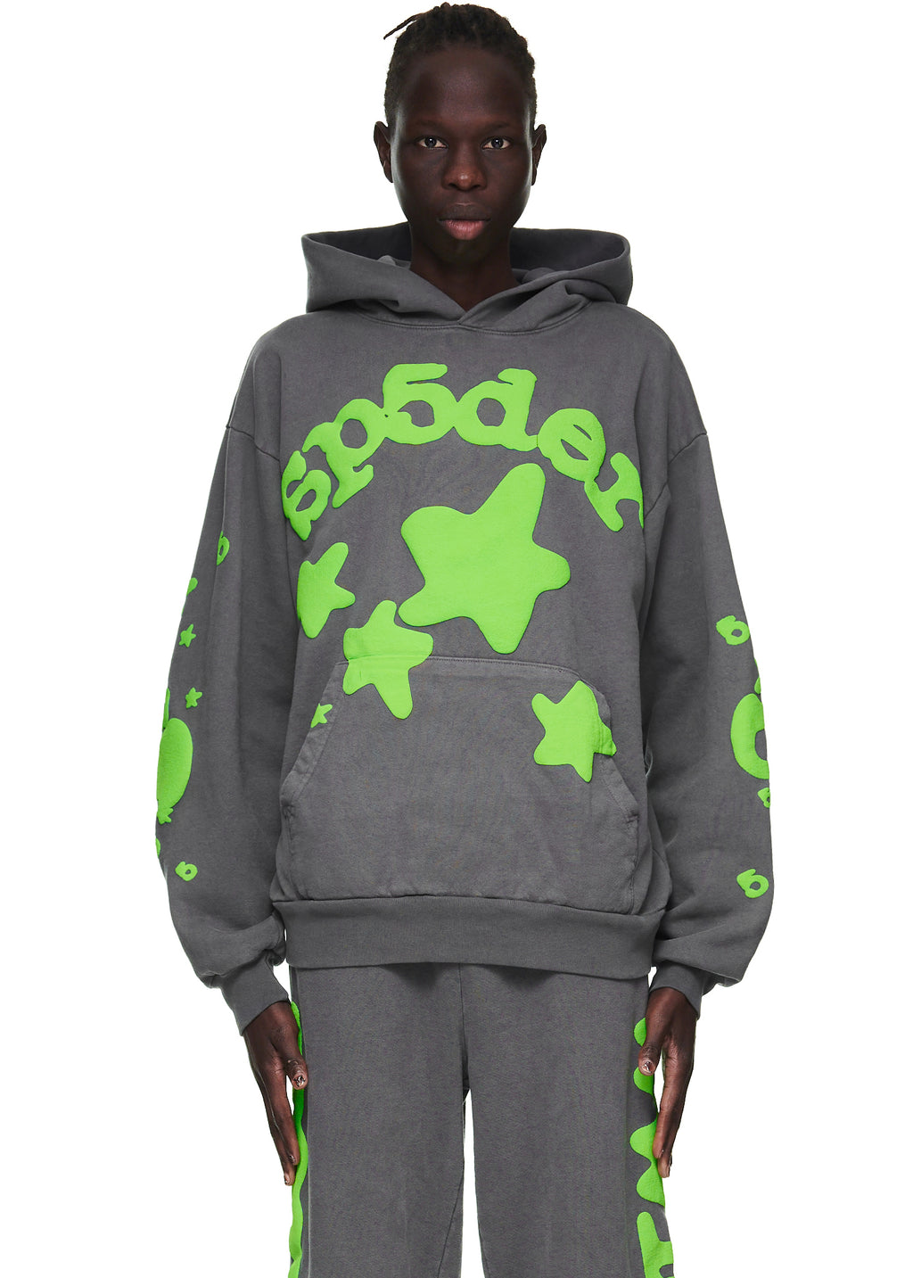 Male model in slate grey Beluga hoodie with neon green 'SP5DER' text and star puff prints.