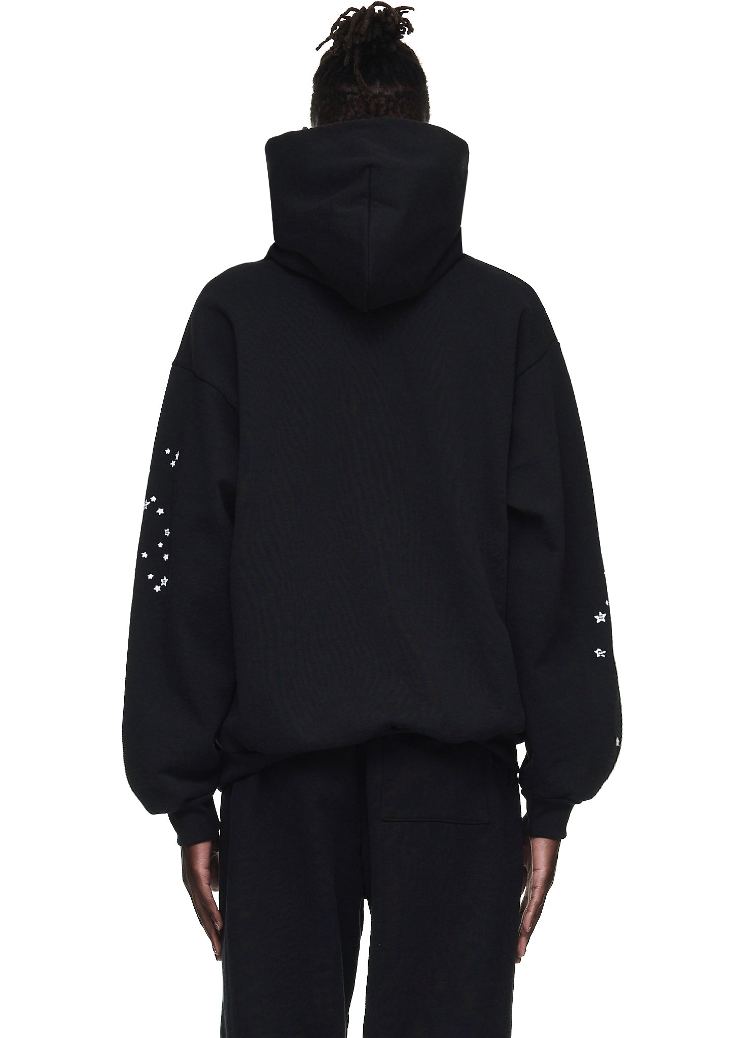 Black OG WEB HOODIE, 23oz fleece, with white star print on sleeves, worn by a model.