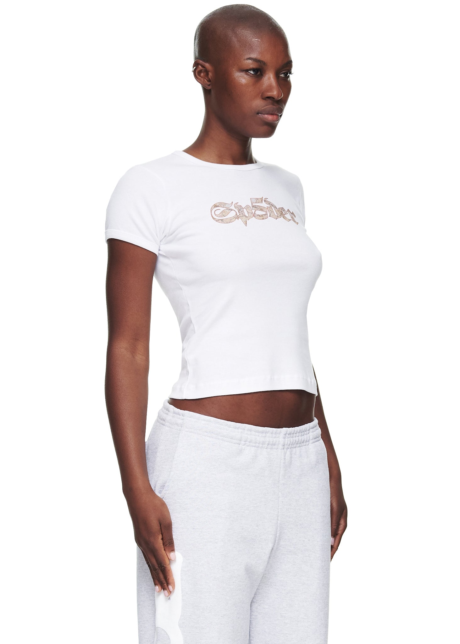 Female model in white cropped fitted cotton baby tee with graphic print.