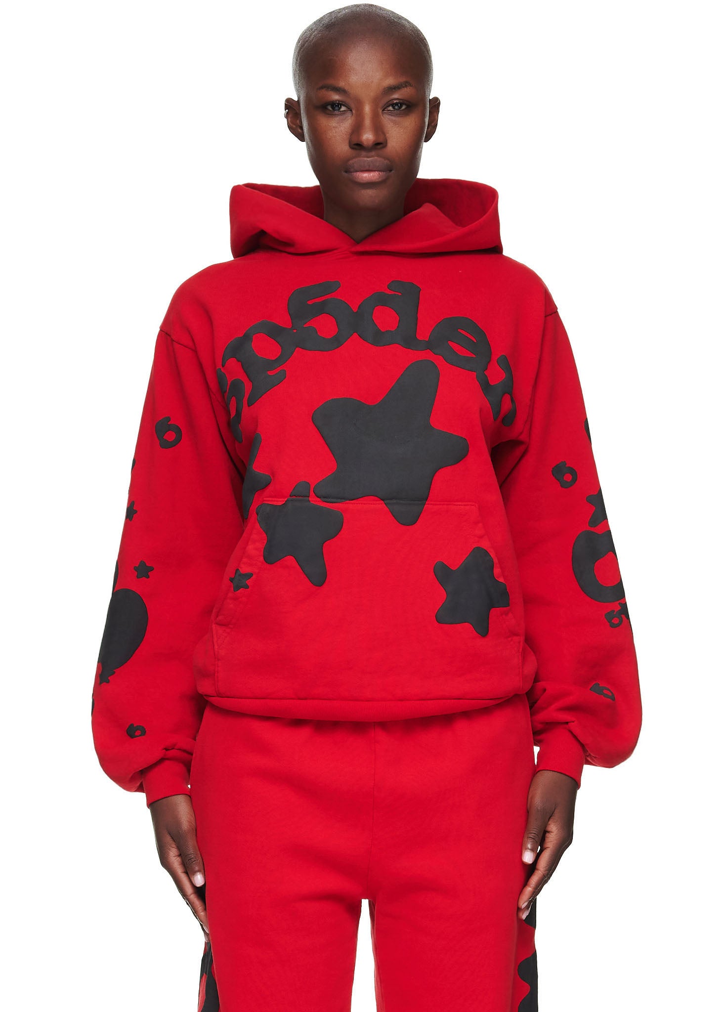 Red Beluga Hoodie with black 'SP5DER' and star puff/discharge print, worn by a female model.
