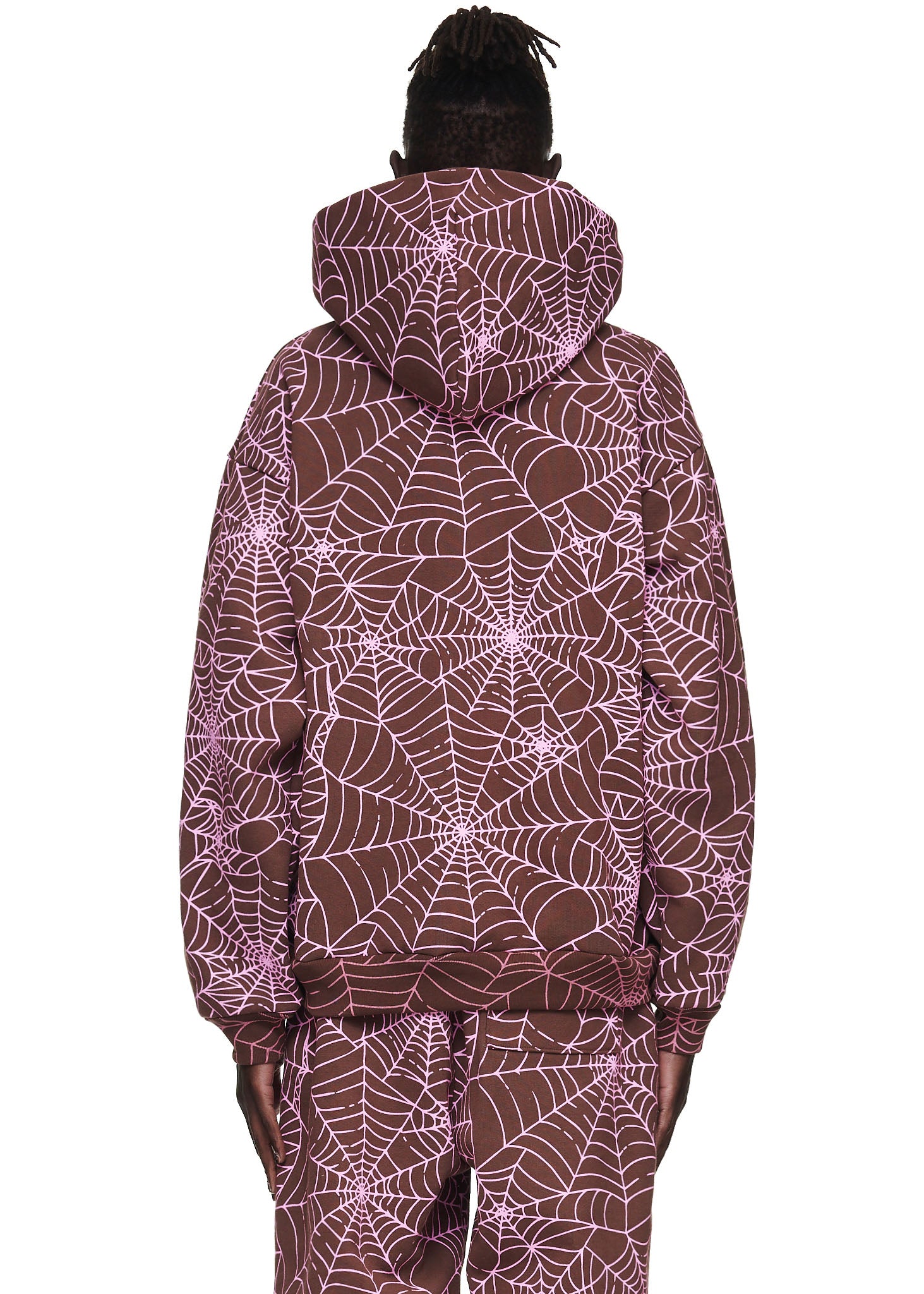 Brown fleece hoodie with all-over cracked pink spider web print, worn by a male model.