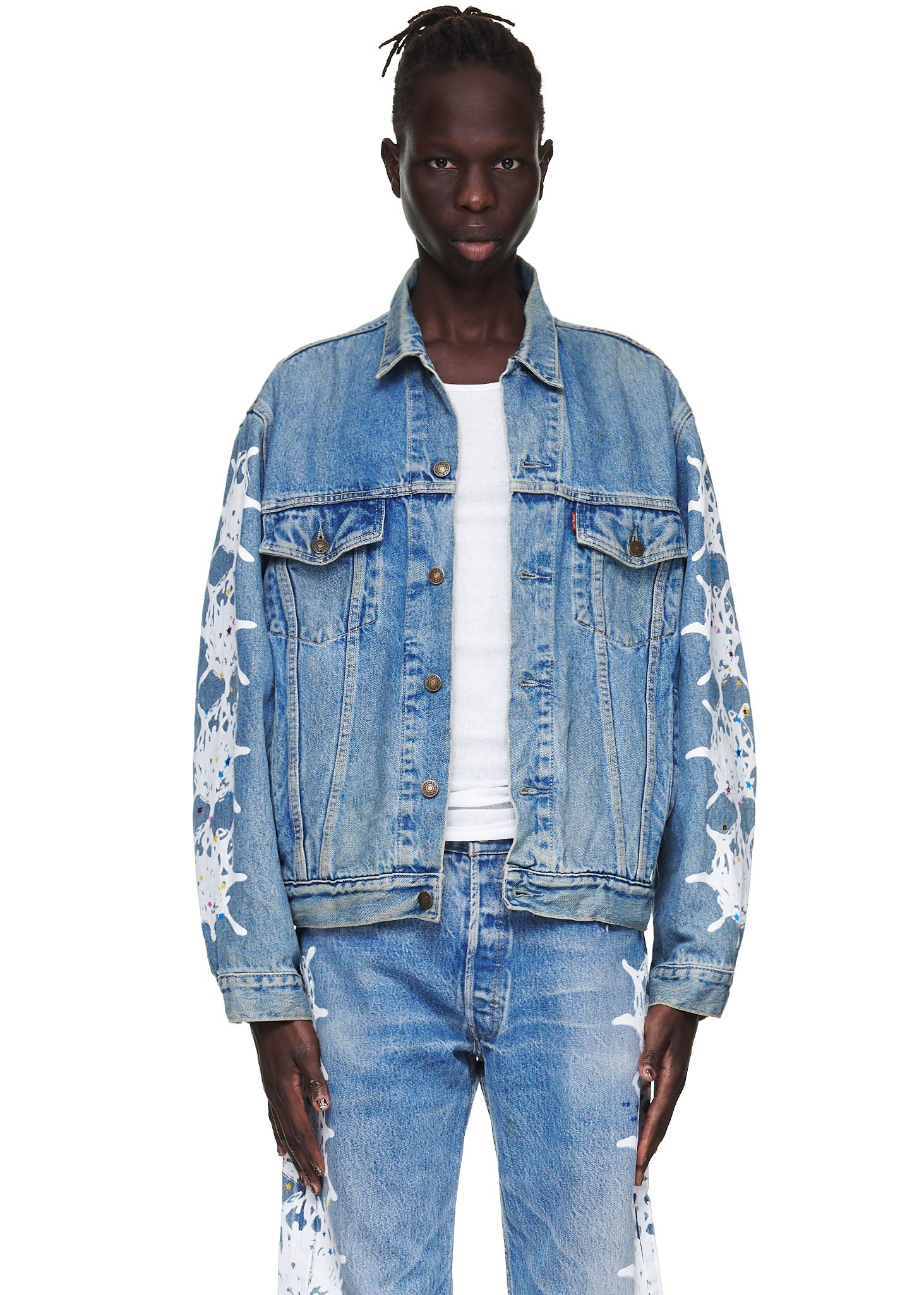 Male model in a vintage Levi's denim trucker jacket with white contrast web design on arms and matching jeans.