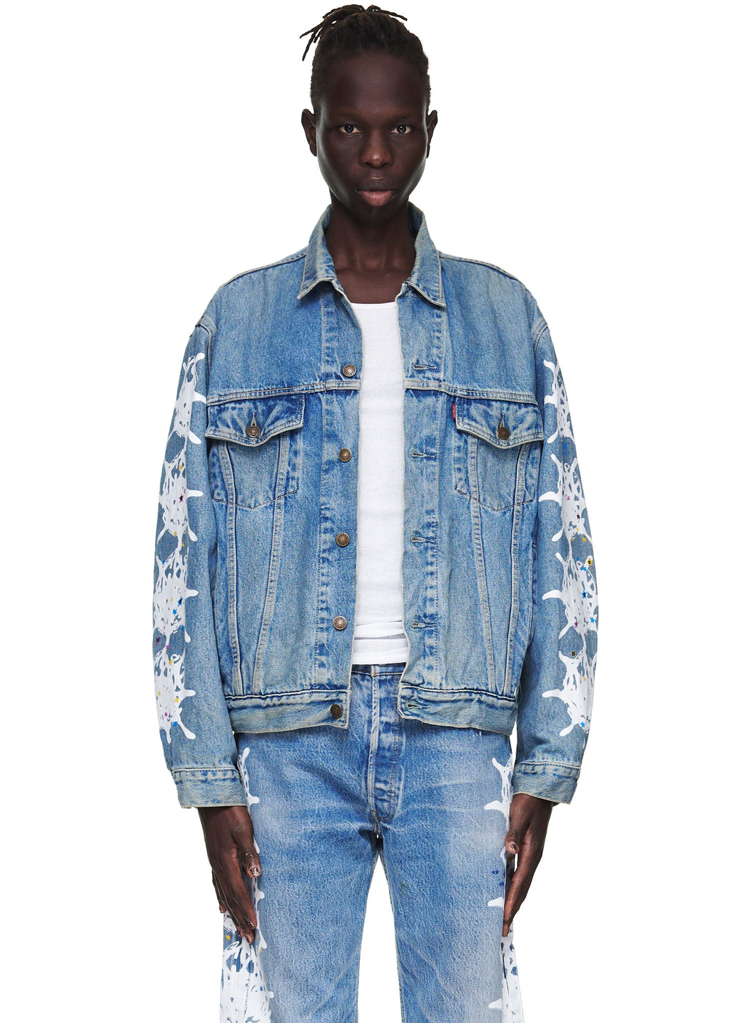 Male model in a vintage Levi's denim trucker jacket with white contrast web design on arms and matching jeans.
