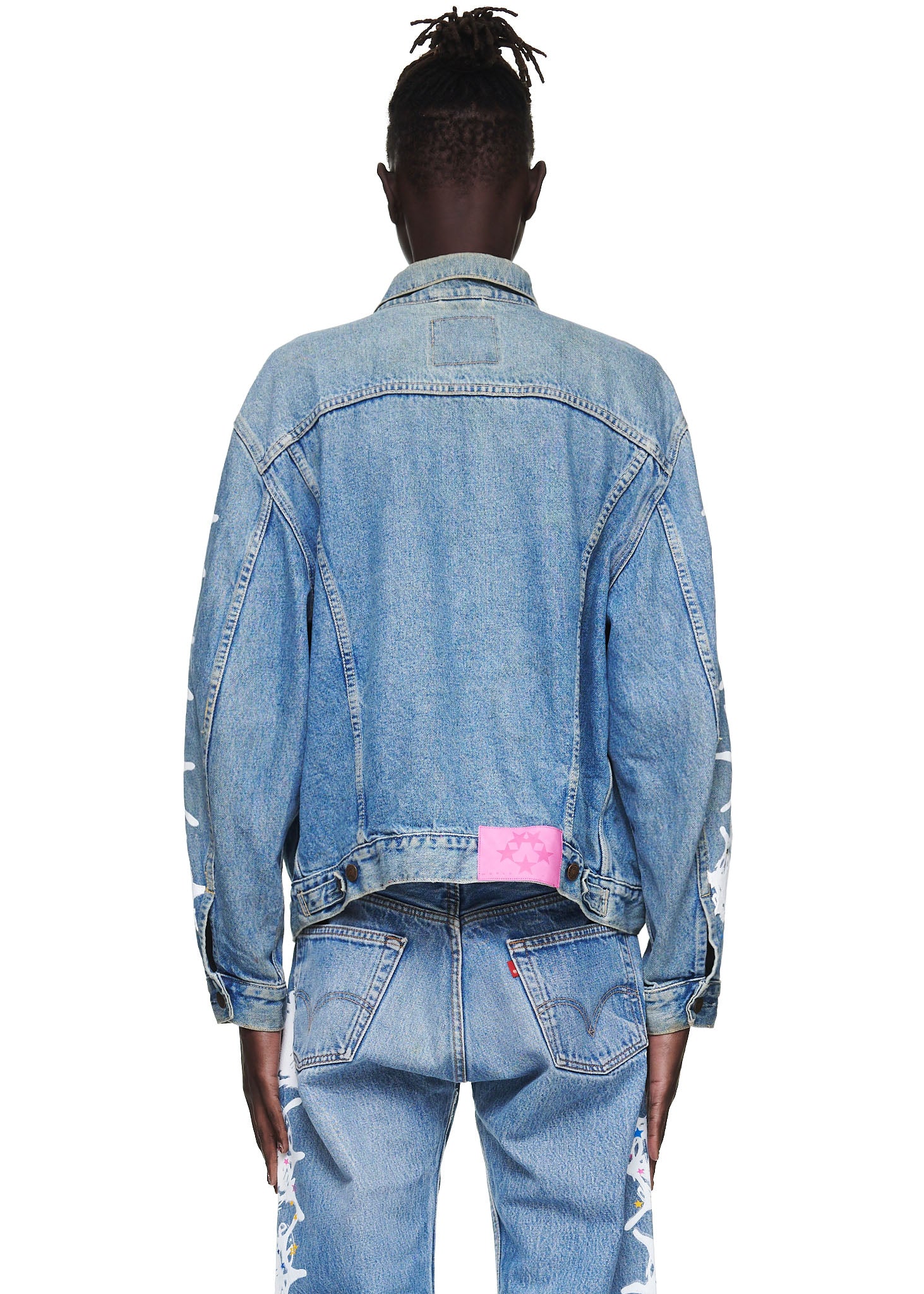 Vintage Levi's denim trucker jacket with a pink SP5DER leather back tab and white contrast web on arms.