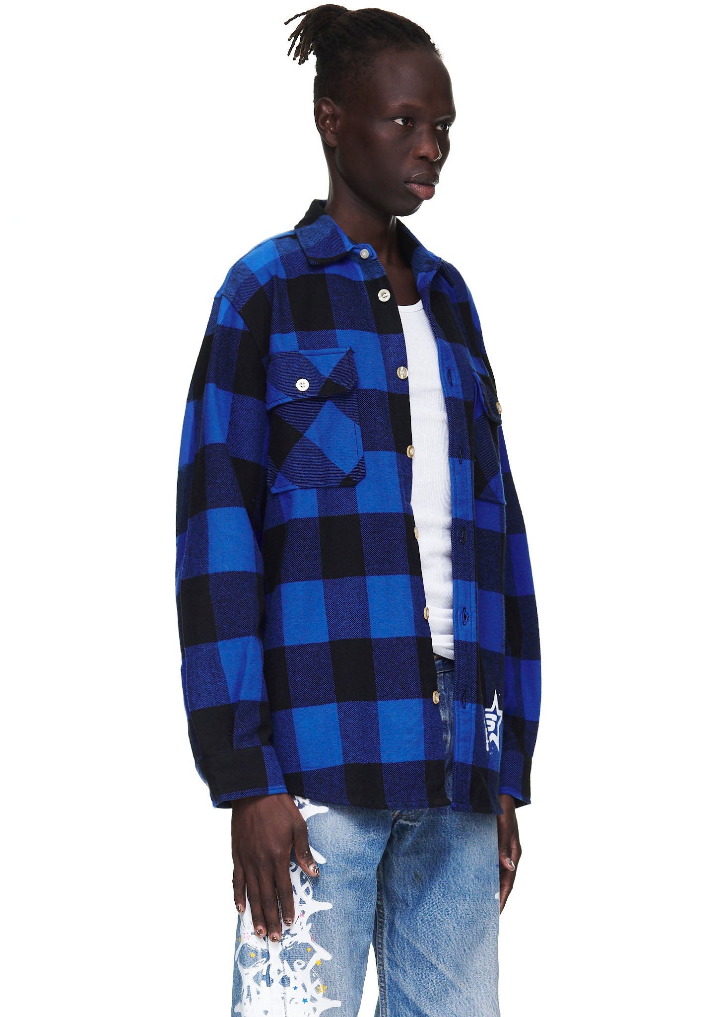 Male model in a blue and black buffalo plaid flannel shirt with patch pockets and a "5" graphic.