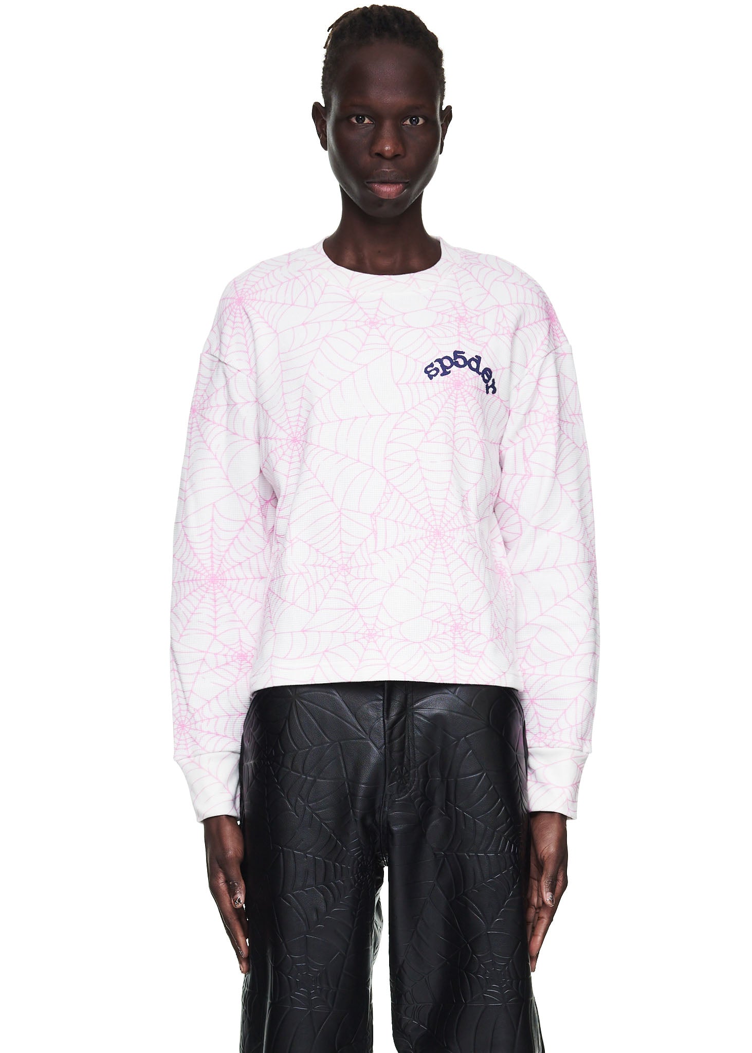 Male model in white waffle thermal long sleeve with pink spiderweb print and "sp5der" logo.