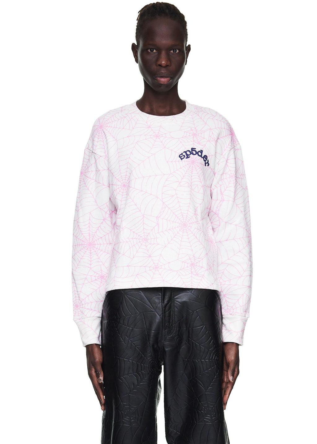 Male model in white waffle thermal long sleeve with pink spiderweb print and "sp5der" logo.