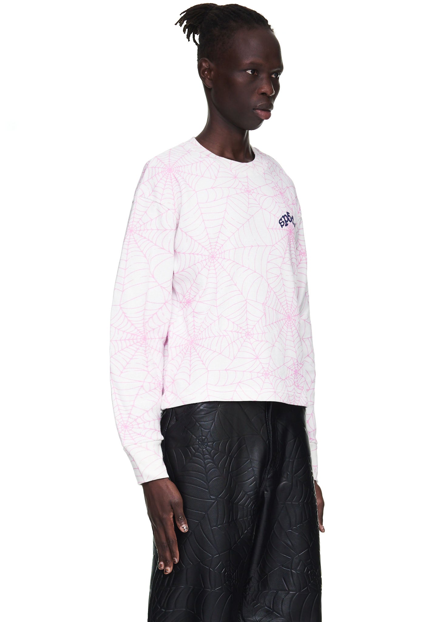Male model in a white waffle thermal long sleeve with pink spiderweb print and "6DC" logo.