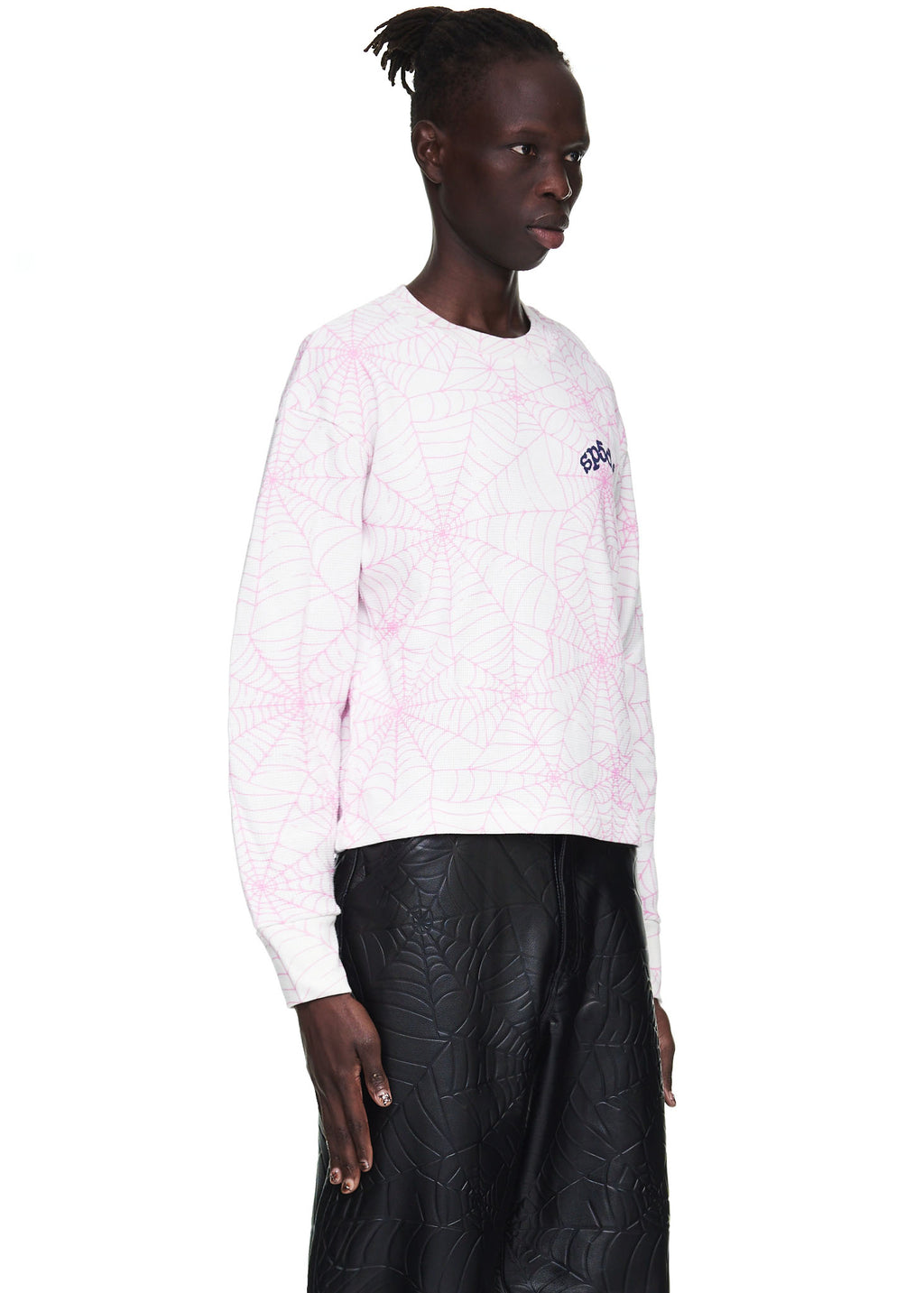 Male model in a white waffle thermal long sleeve with pink spiderweb print and "6DC" logo.
