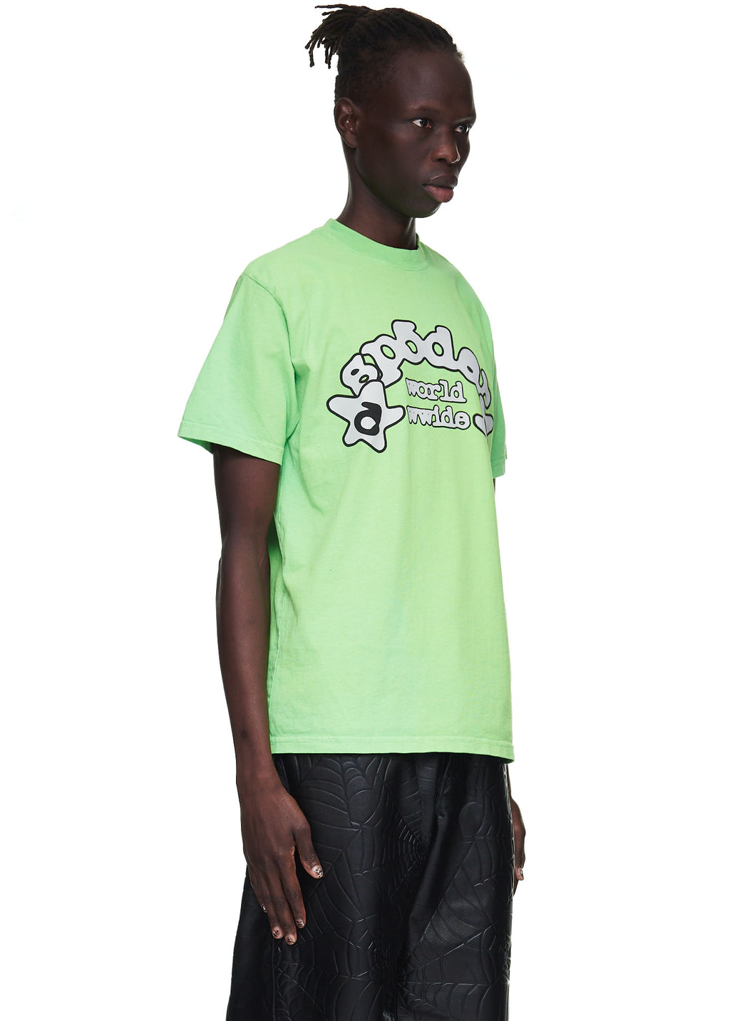Male model in a standard fit, slime green 100% cotton tee with a "worldwide" graphic print.