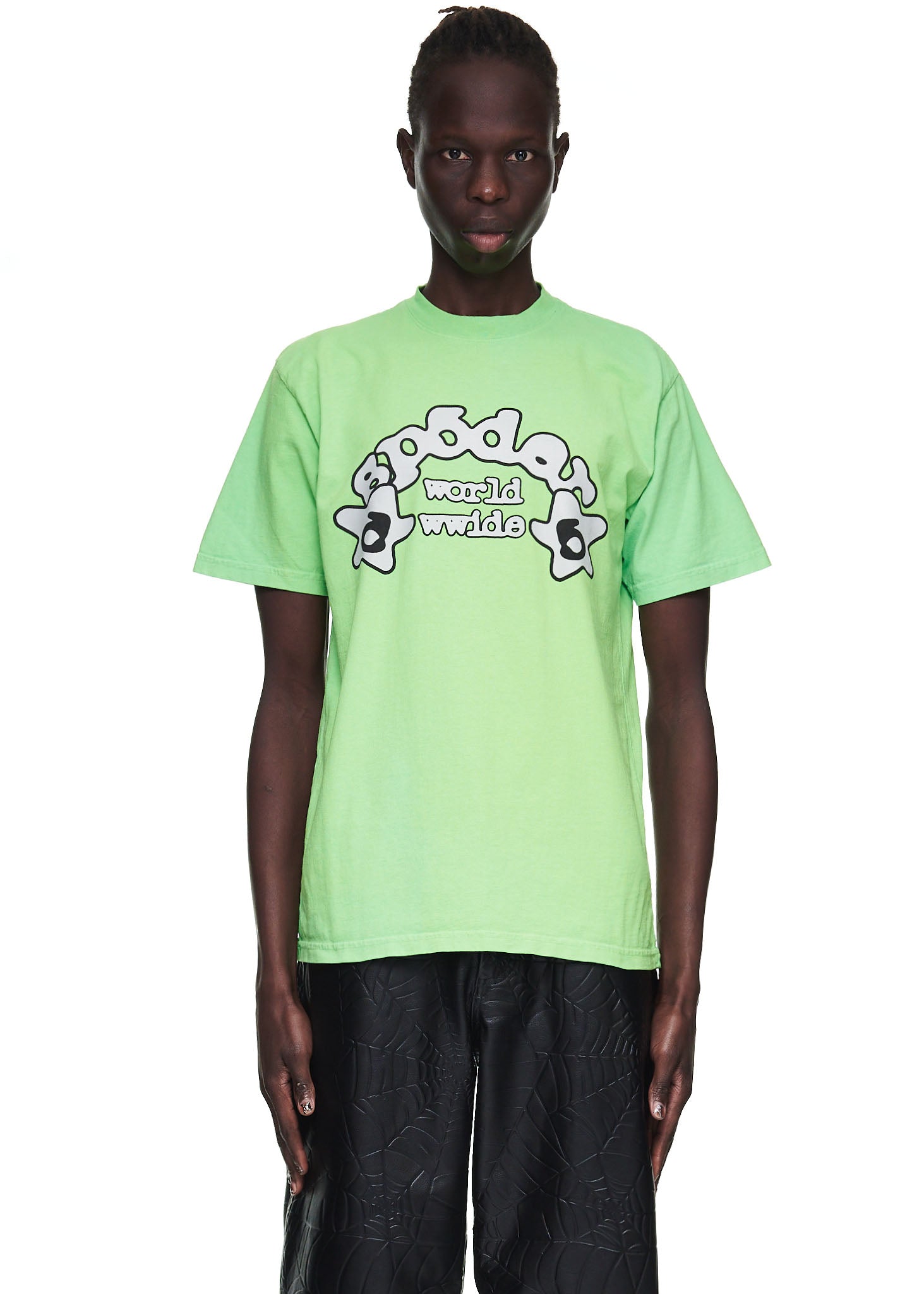 Male model wears a standard fit slime green 100% cotton tee with "world wwide" graphic print.