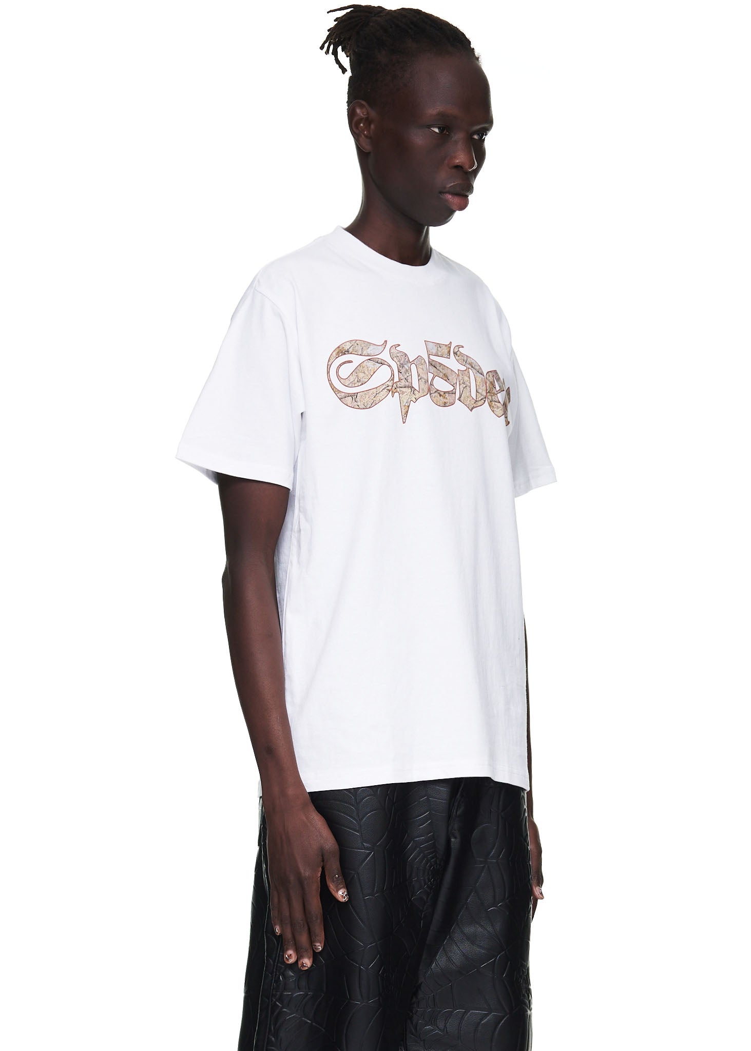 Male model in a white 100% cotton standard fit tee with a brown graphic print on the front.