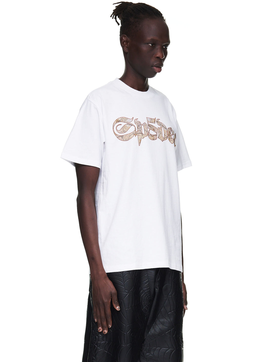 Male model in a white 100% cotton standard fit tee with a brown graphic print on the front.