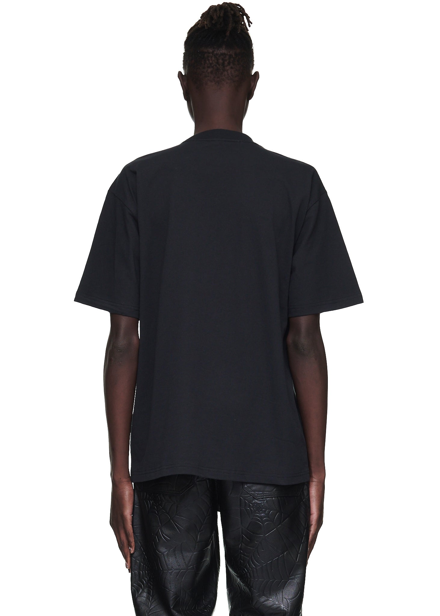 Back view of a male model wearing a plain black 100% cotton standard fit tee.