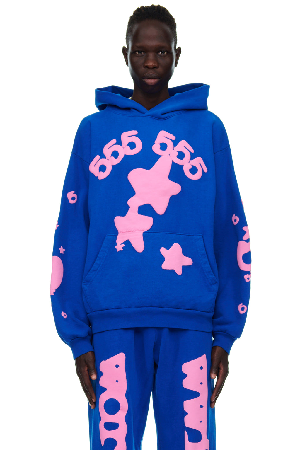 Male model in a blue fleece hoodie with pink puff print '555' and star designs, matching sweatpants.