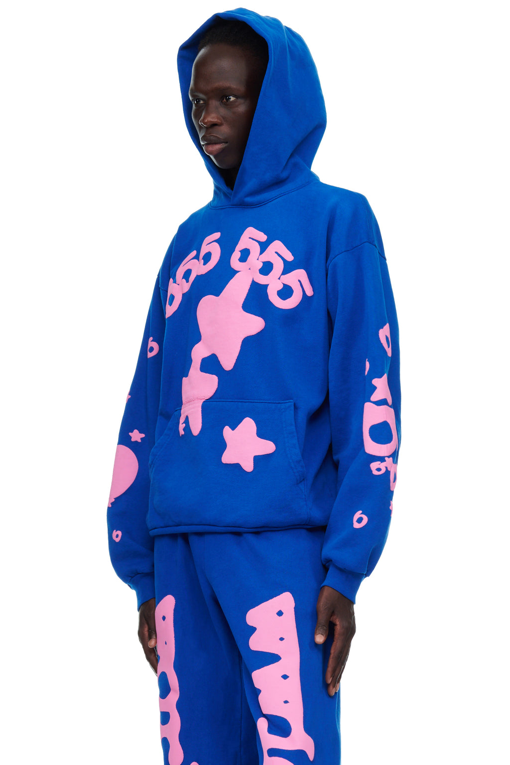 Male model in a blue fleece hoodie with pink puff print '555' and star designs.