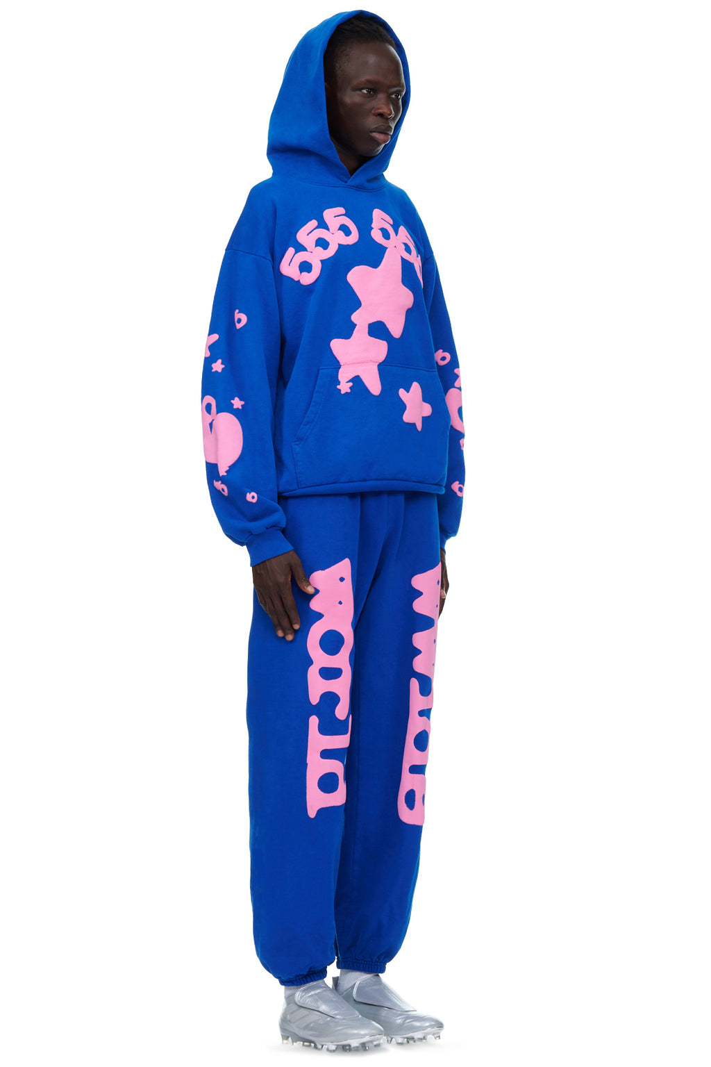 Male model in blue 23oz fleece hoodie and sweatpants with pink puff print designs.