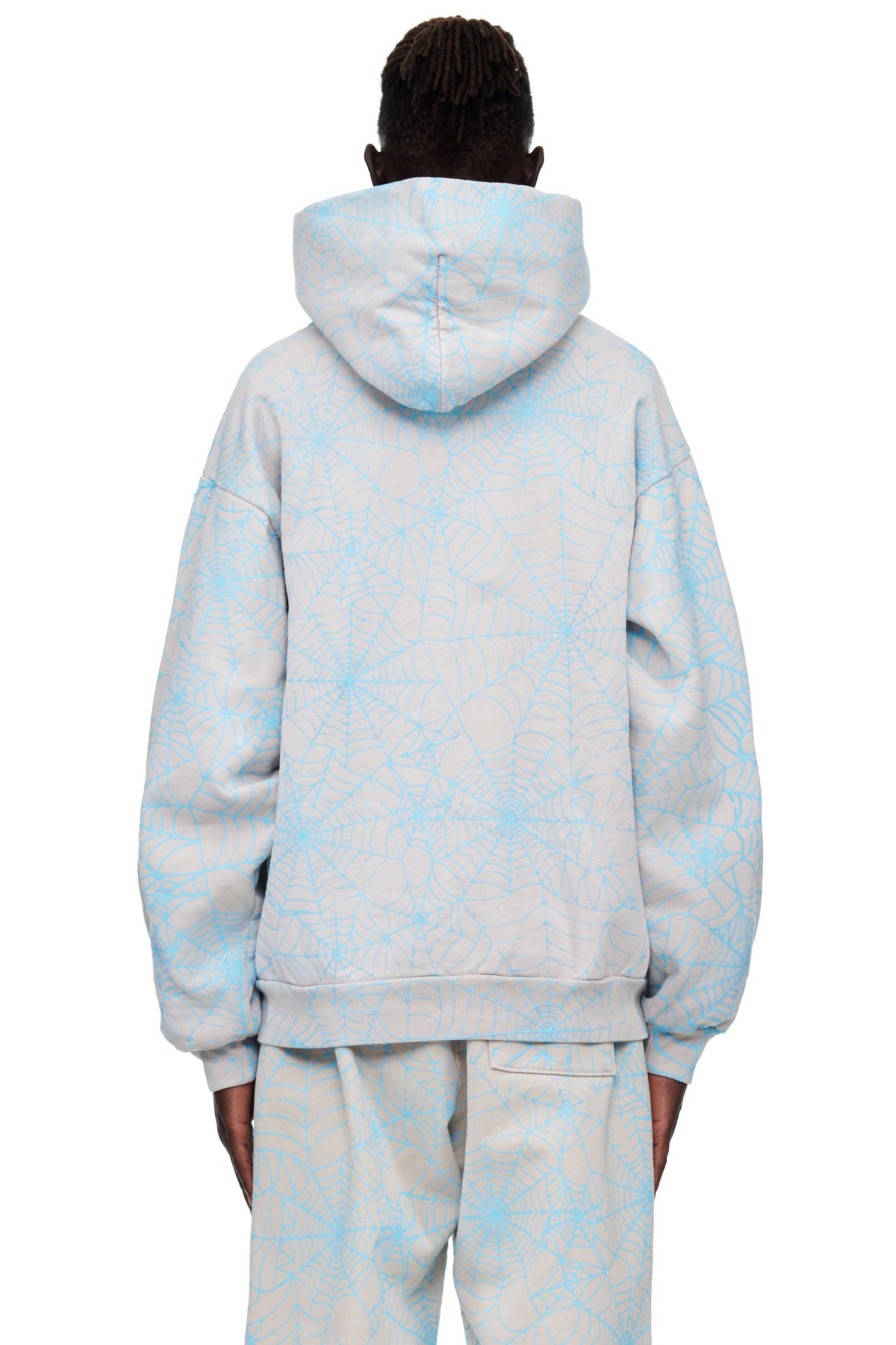 Back view of a light grey AOP WEB HOODIE with an all-over cracked blue spider web print.