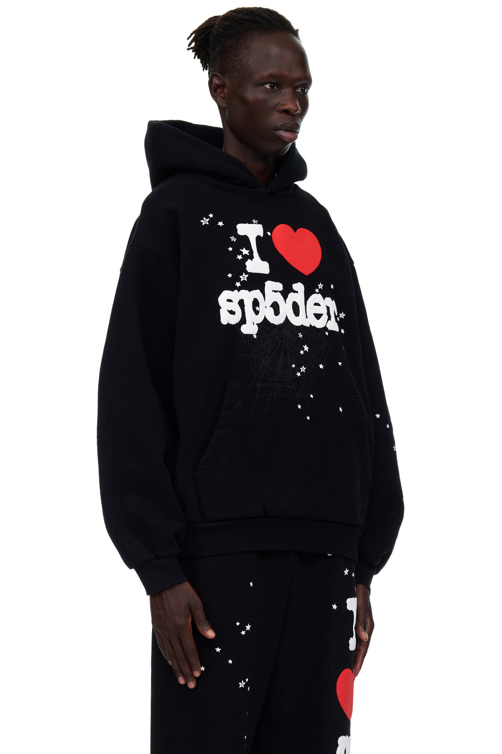 Black fleece hoodie with "I HEART SP5DER" puff print, white stars, and web detail. Male model wears size L.
