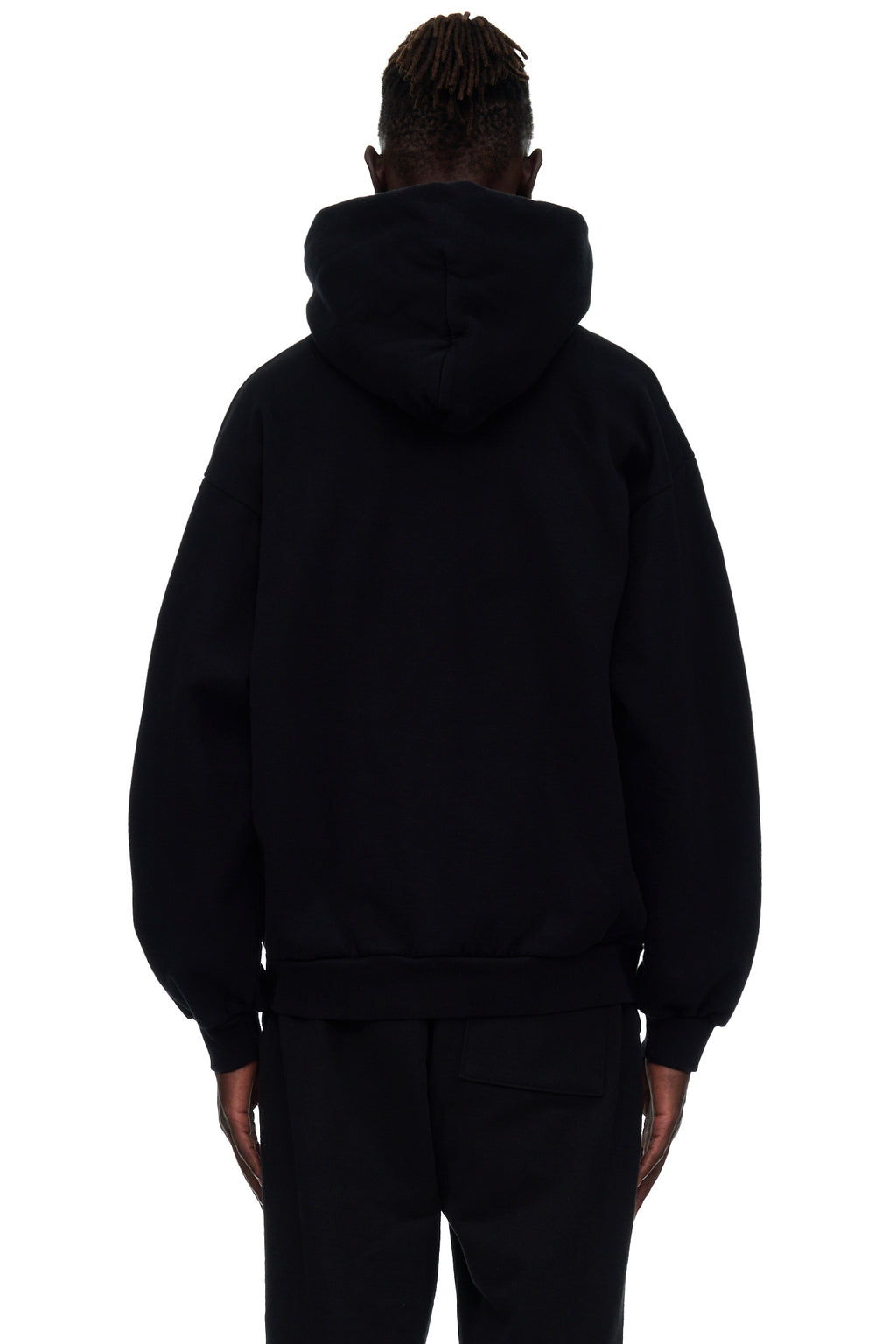 Back view of a black 23oz fleece hoodie worn by a male model, showing the hood and ribbed hem.