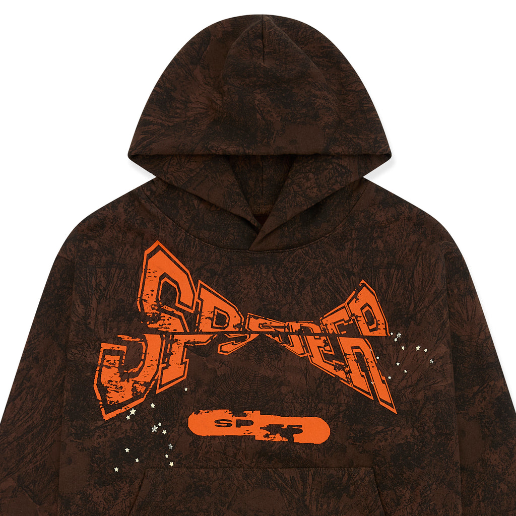 Brown tree camo hoodie with orange puff print "SP5DER" chest text and white stars.