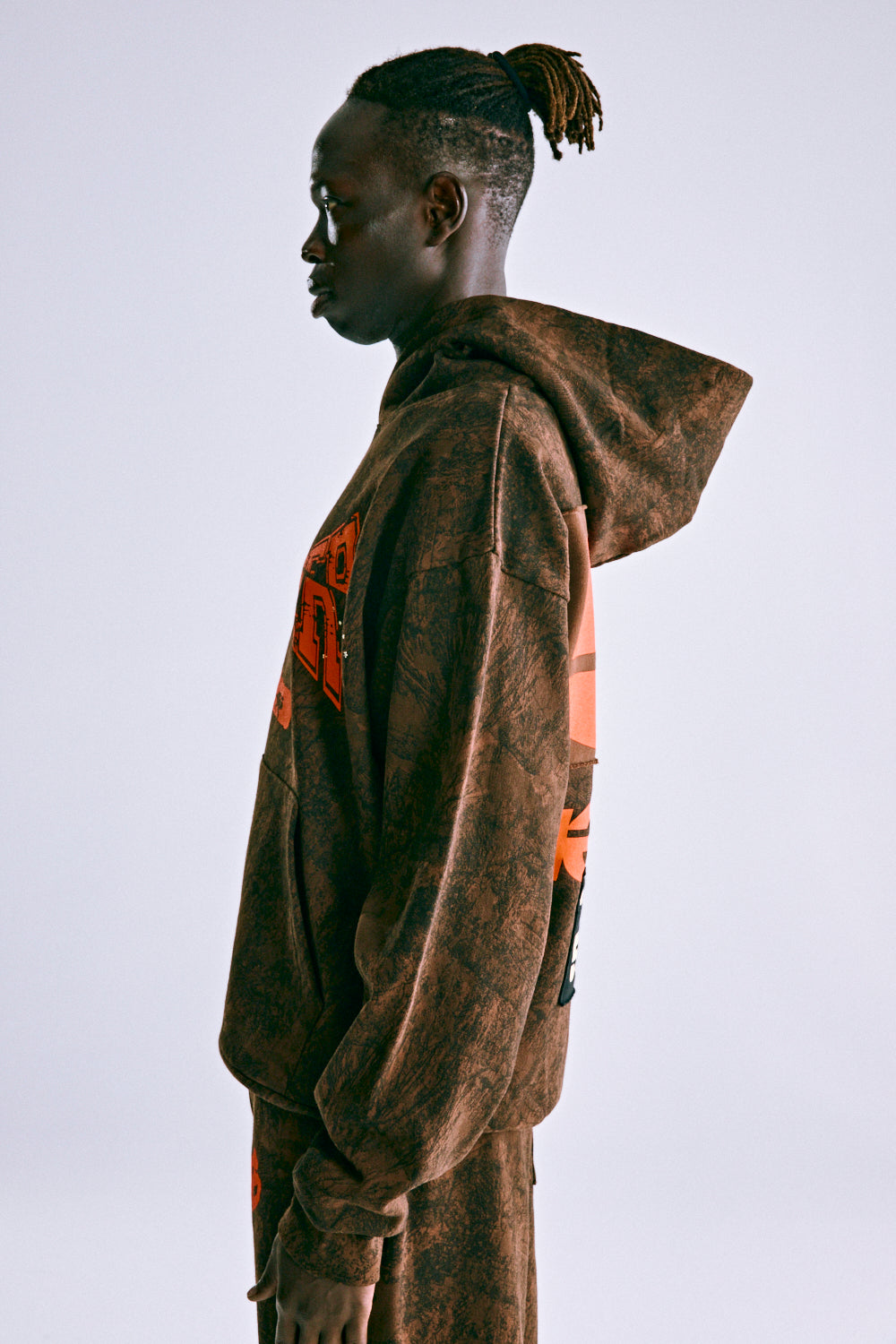 Brown 13oz cotton fleece T&F TREE CAMO HOODIE with orange 'SP5DER' text and racing patch.