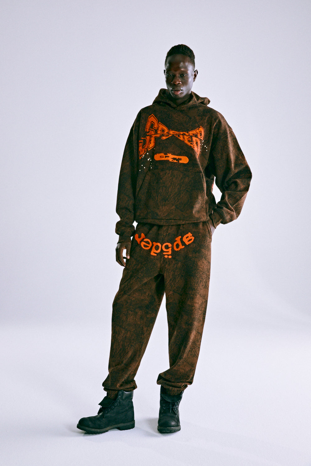 Brown tree camo hoodie and sweatpants with orange "SP5DER" puff print.