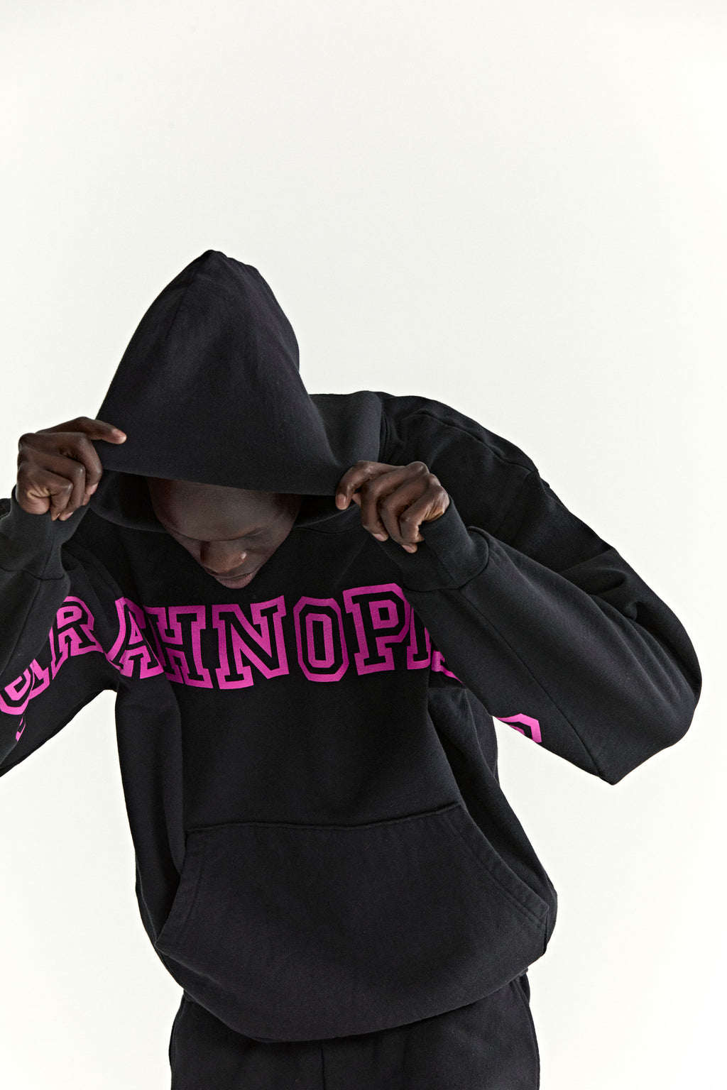 Black ARACH HOODIE with bold pink puff print text on chest and arms, kangaroo pocket, and hood.